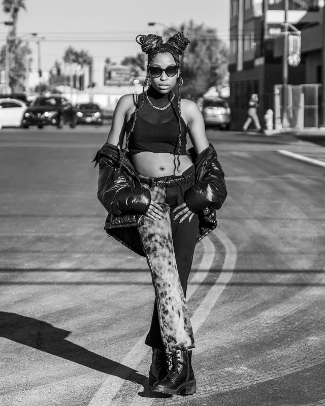 Black and white photography series showcasing fashion poses on a city street with dramatic shadows.