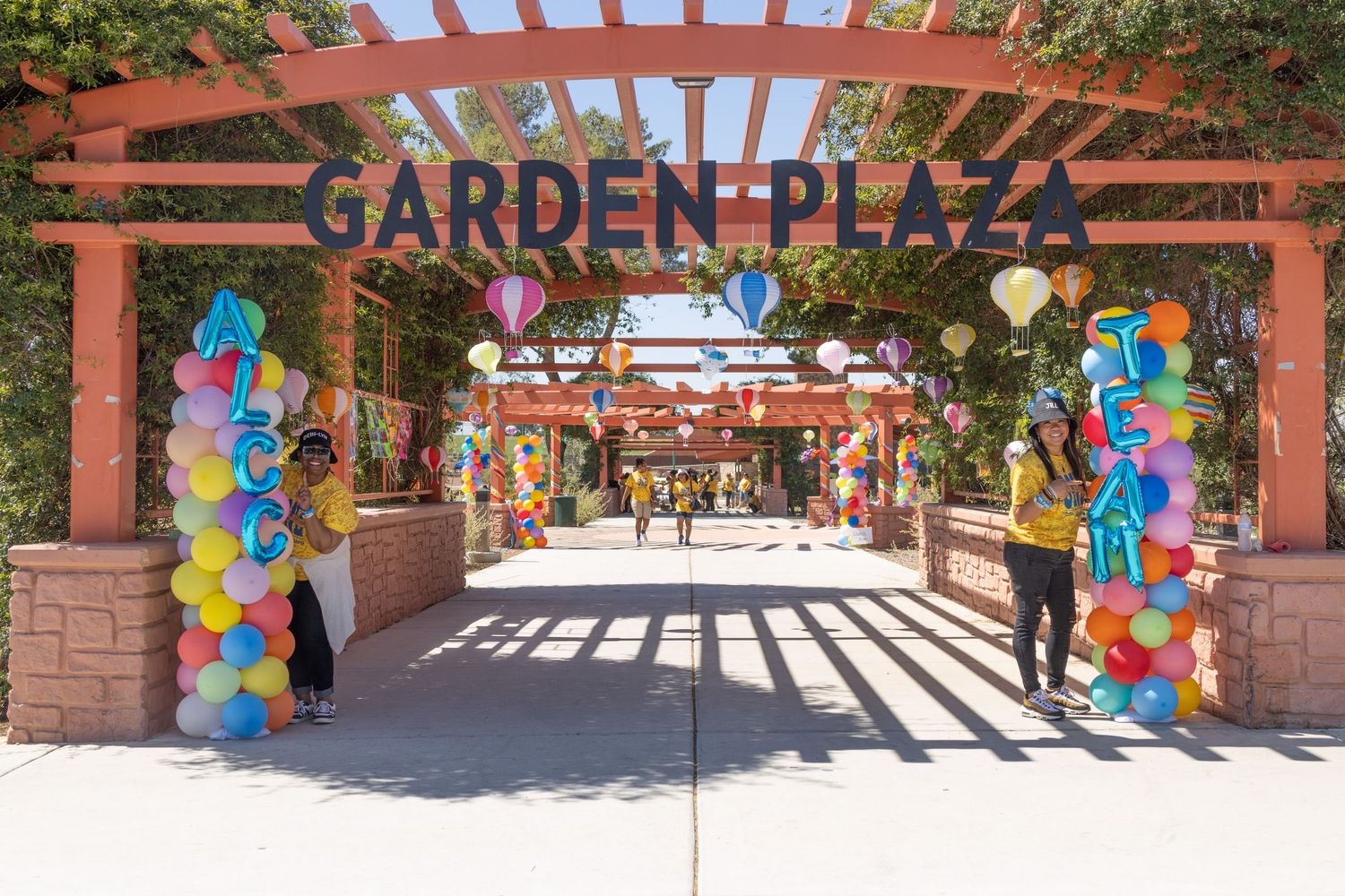 Garden Plaza entrance decorated with colorful balloon arches and wooden lattice structure.