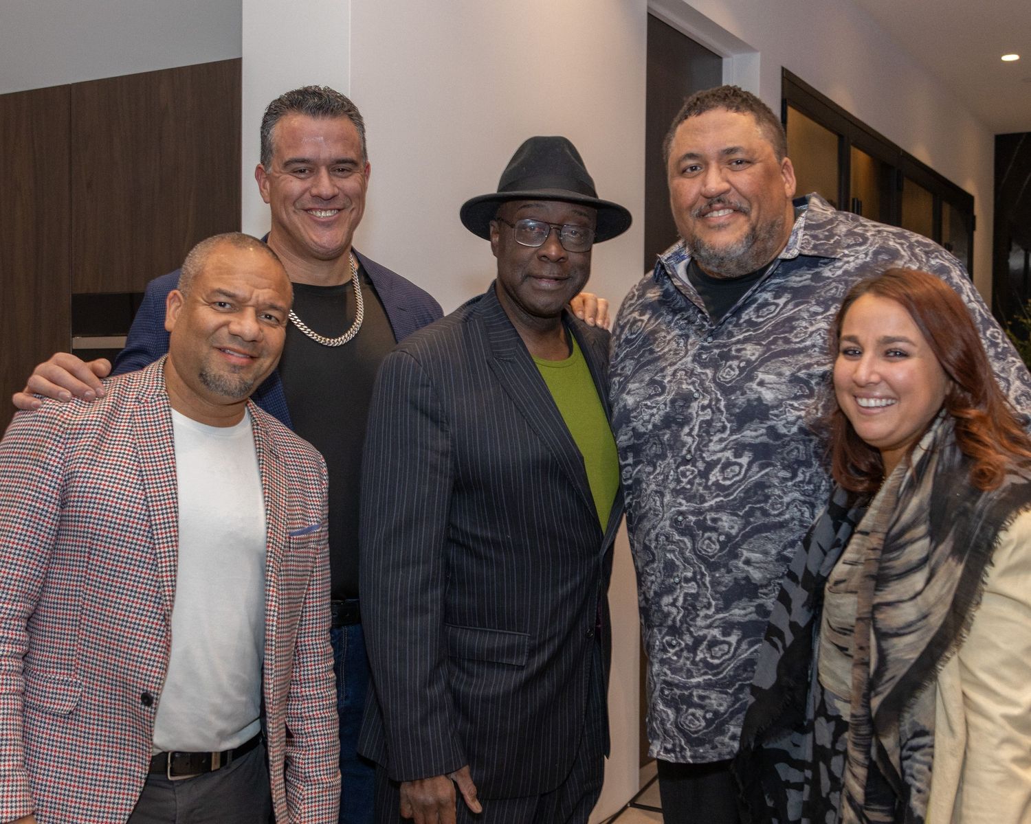 Guests in formal attire networking at an indoor reception event.