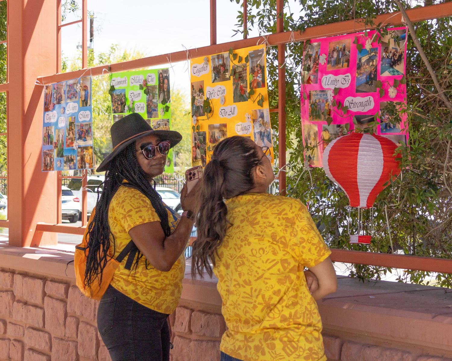 Team members in matching yellow shirts coordinating activities at an outdoor venue.