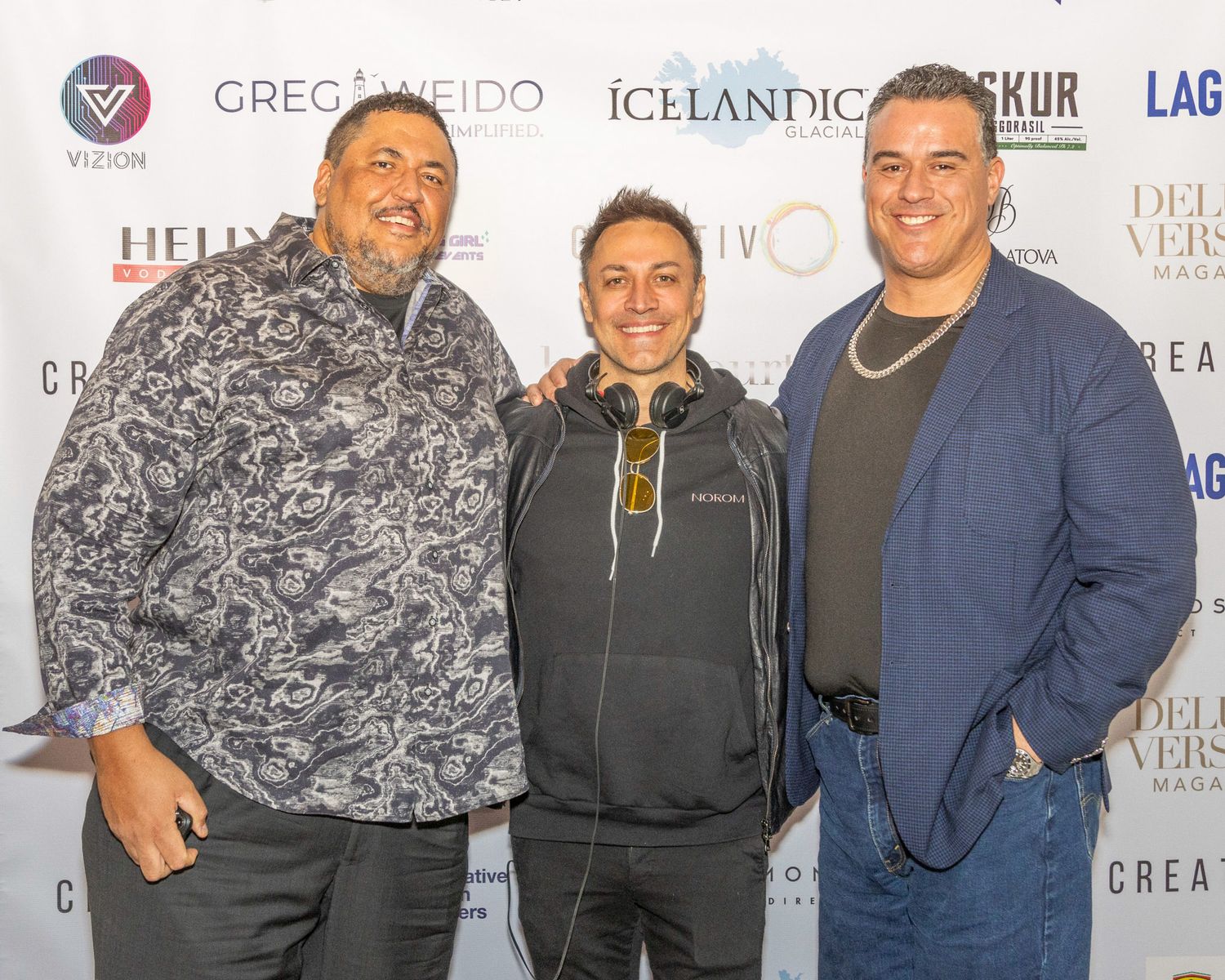 A group of people posing together at an event backdrop with branded logos and text visible in the background. Ex- nfl player. Jackson Crisp