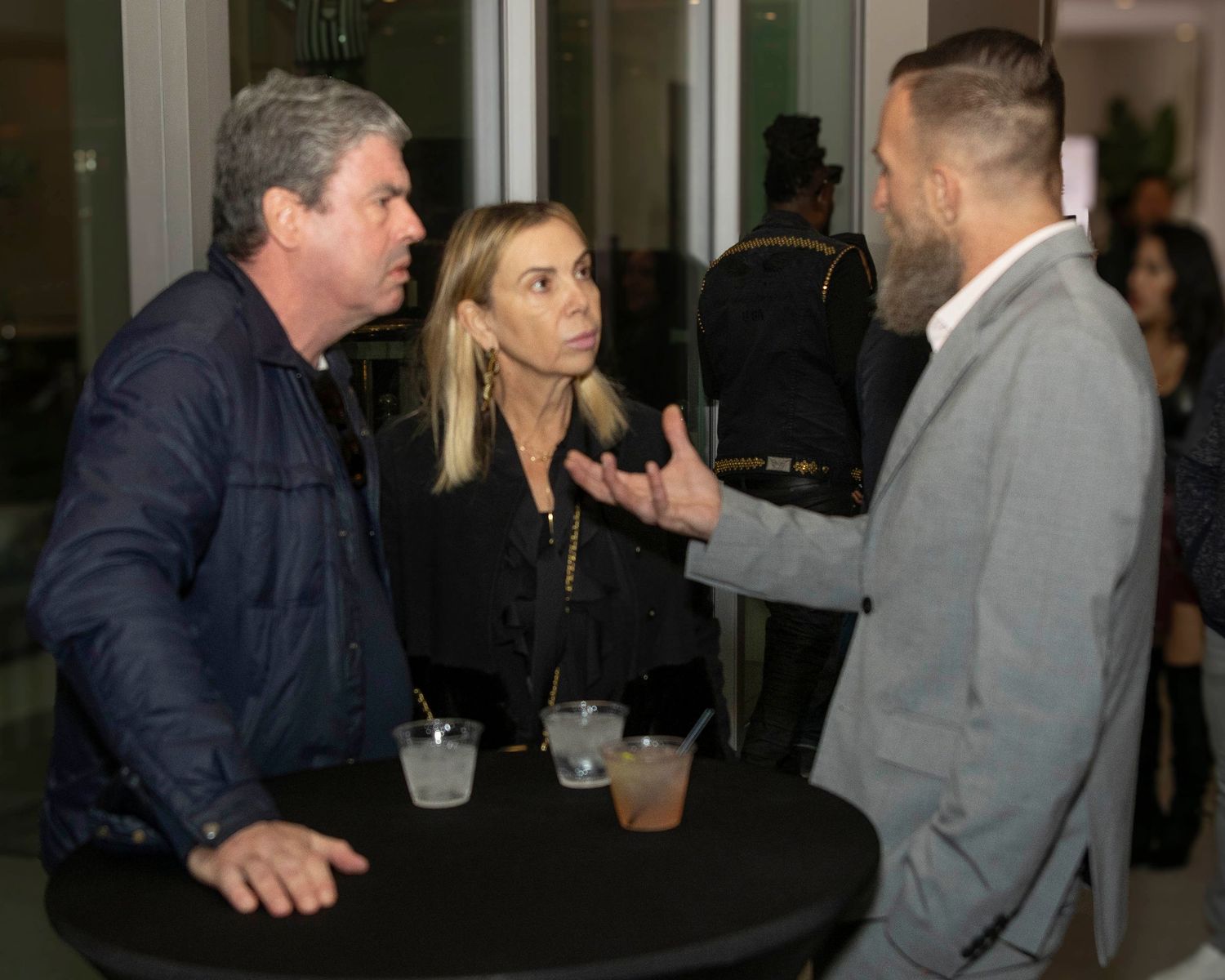 People mingling and networking at an indoor social event in formal attire. Shane Brown