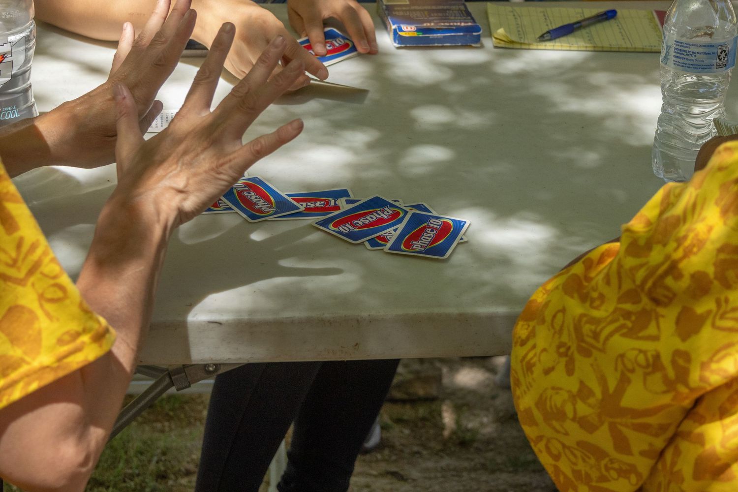 Participants engaged in a hands-on activity at tables during an outdoor event.