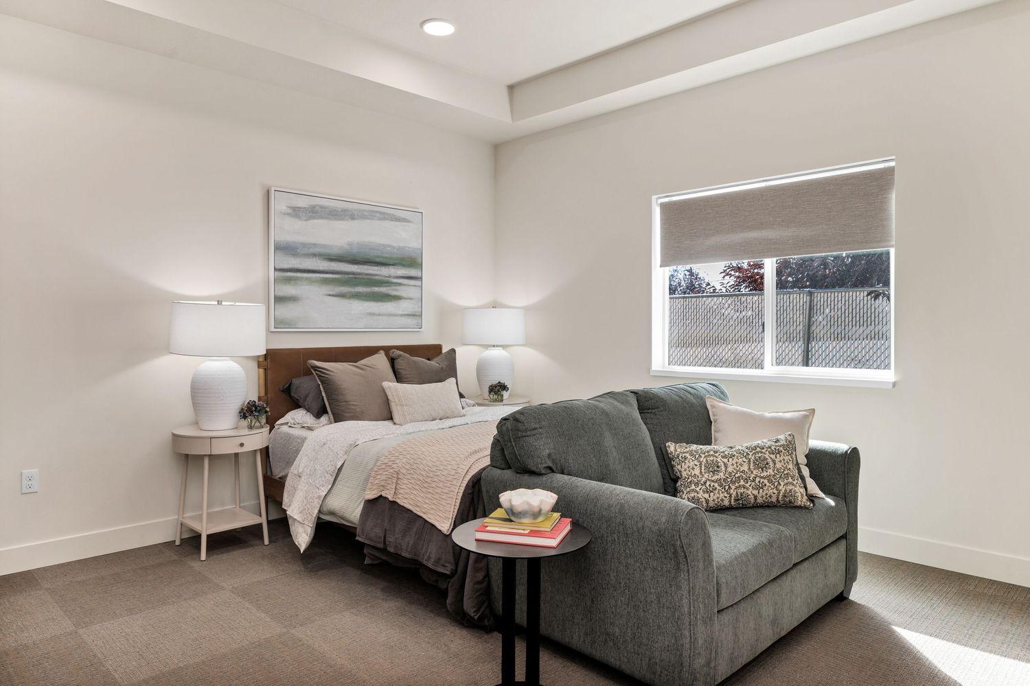 Contemporary living room with gray couch and minimalist decor.