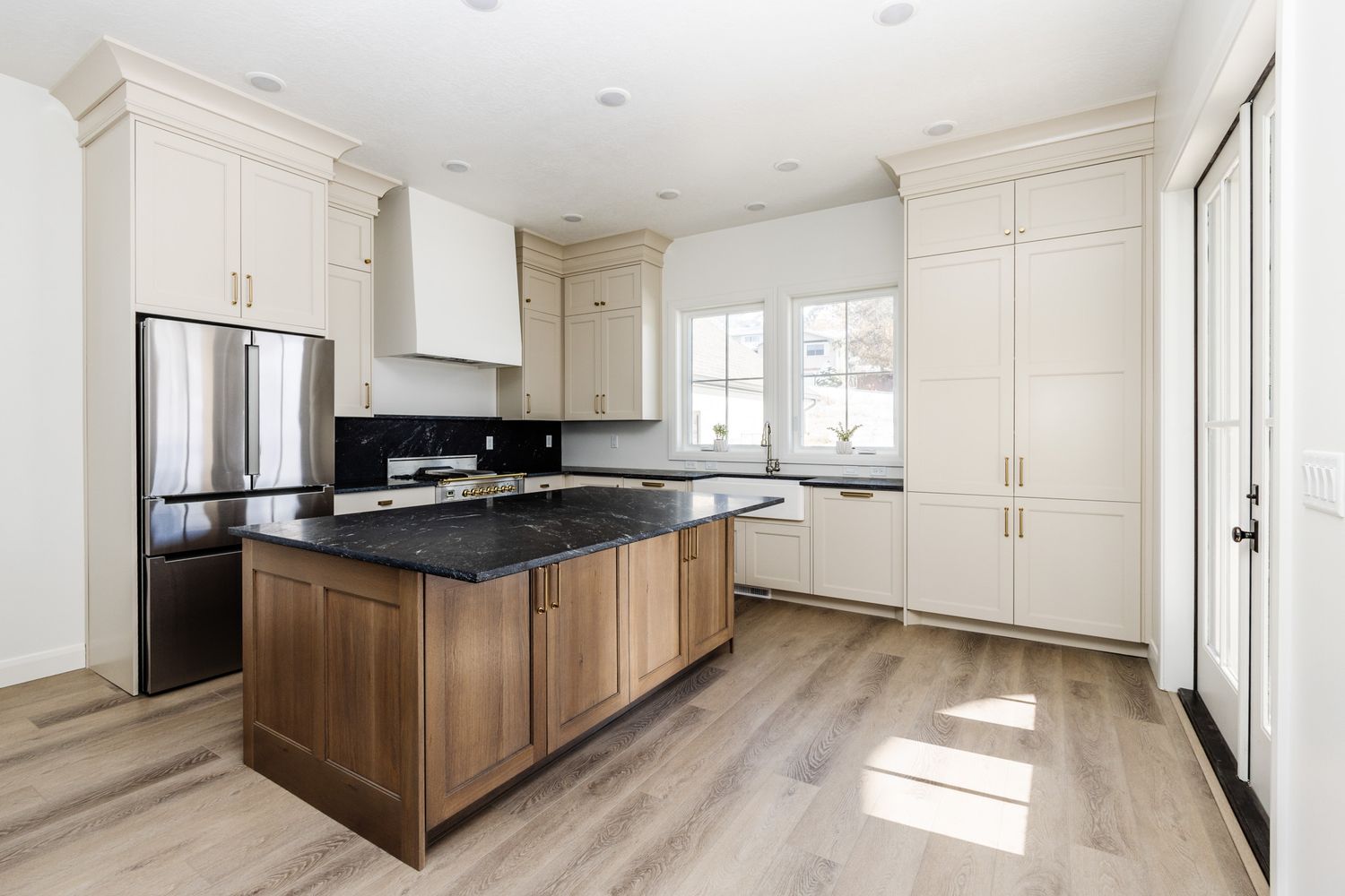 Contemporary kitchen design with wooden cabinets, white walls, and sleek appliances.