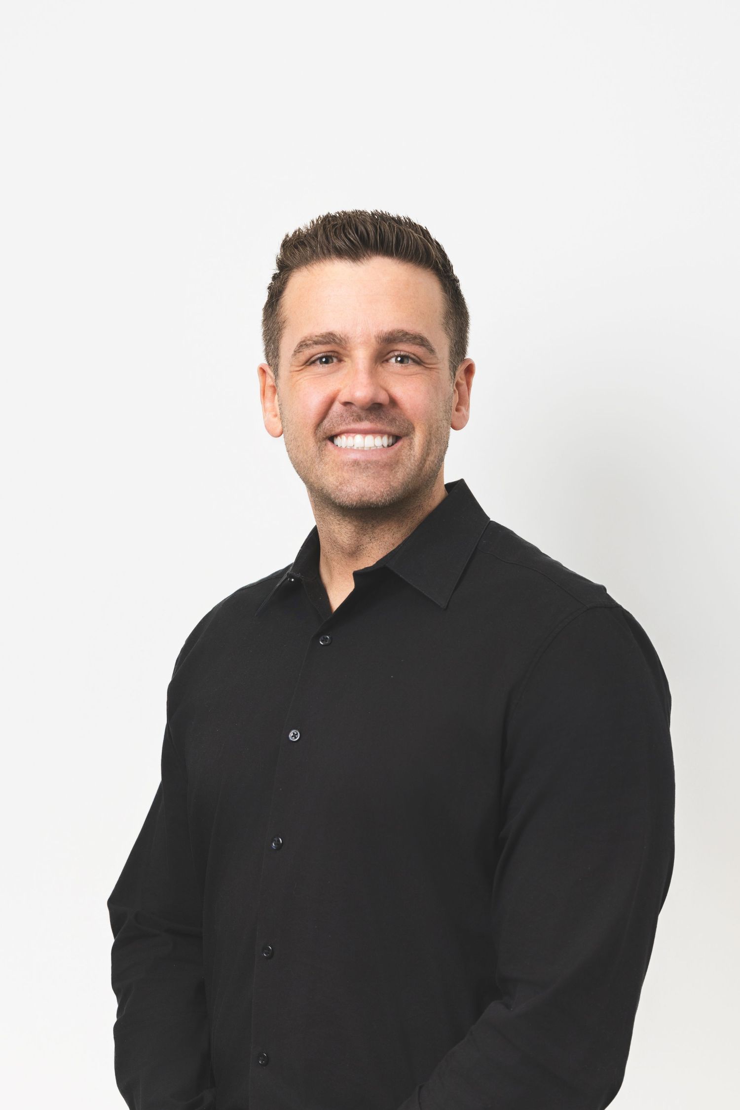 Professional headshots against white background wearing a black button-up shirt.