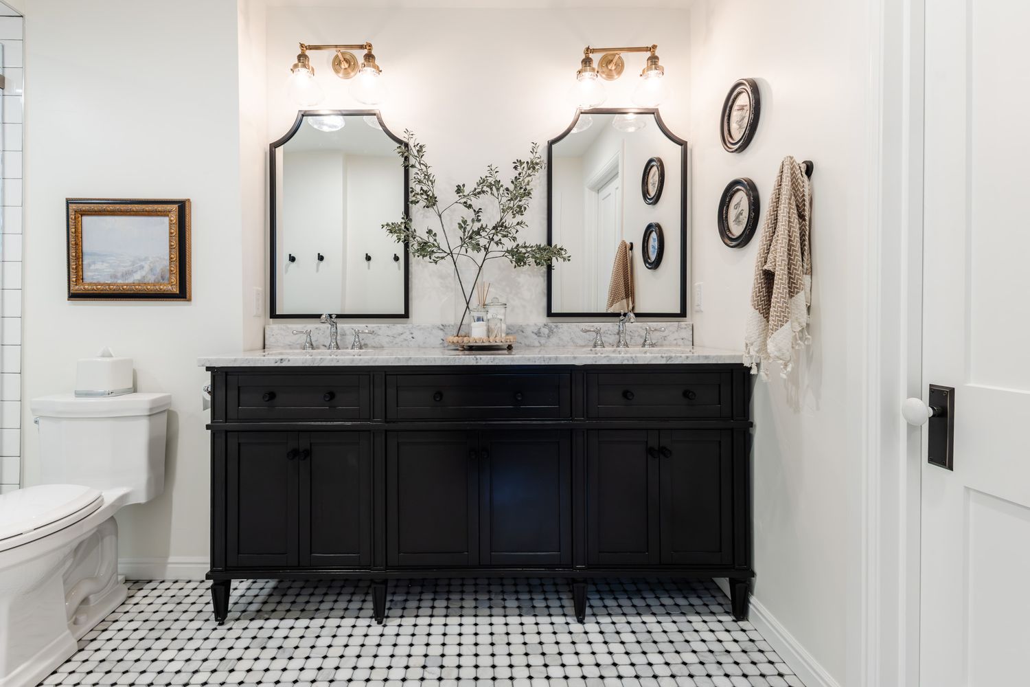 Black and white bathroom with vintage-style fixtures and checkered floor tiles.