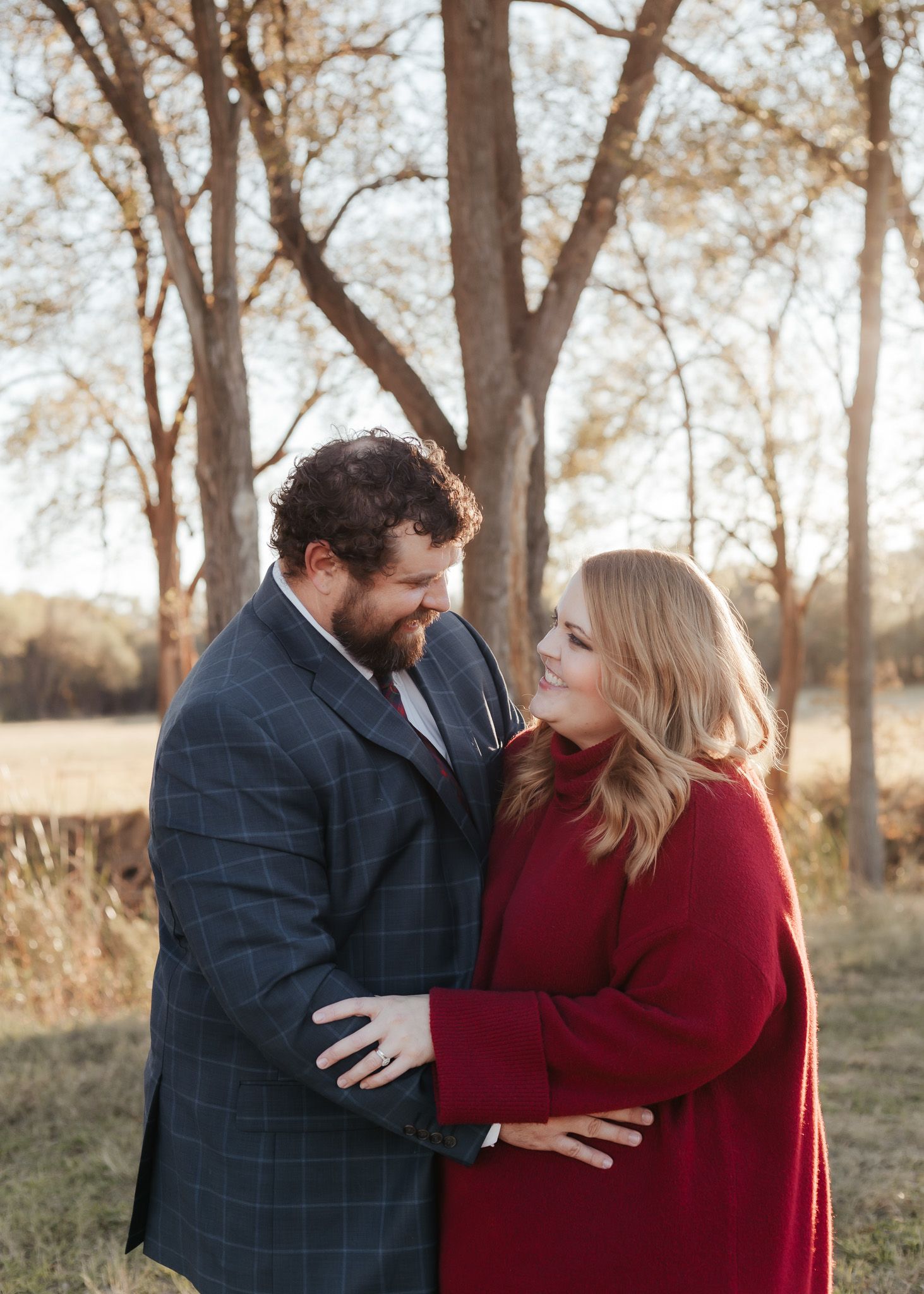 Couple in formal attire sharing intimate moment during outdoor photo session.