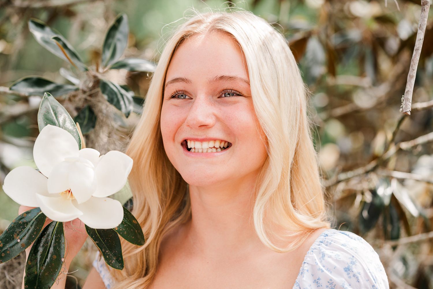 Close-up lifestyle portraits with white magnolia flowers in natural springtime lighting.