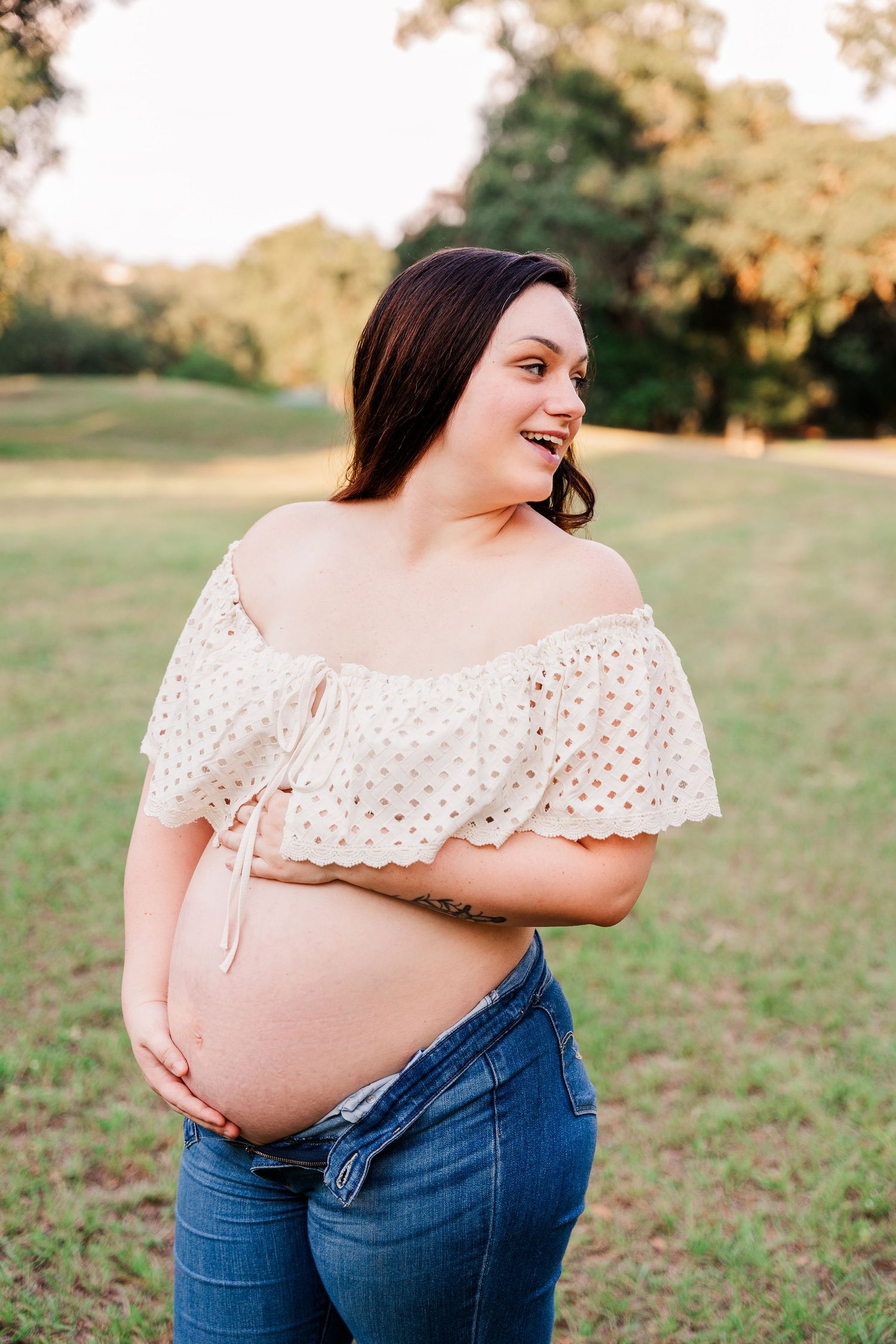 A series of maternity photos showing a white eyelet cropped top and blue jeans against a sunny outdoor setting.