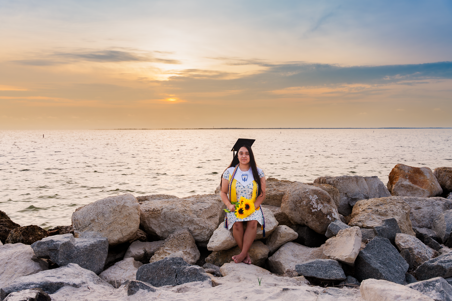 Sunset beach photography session among rocky coastal formations.