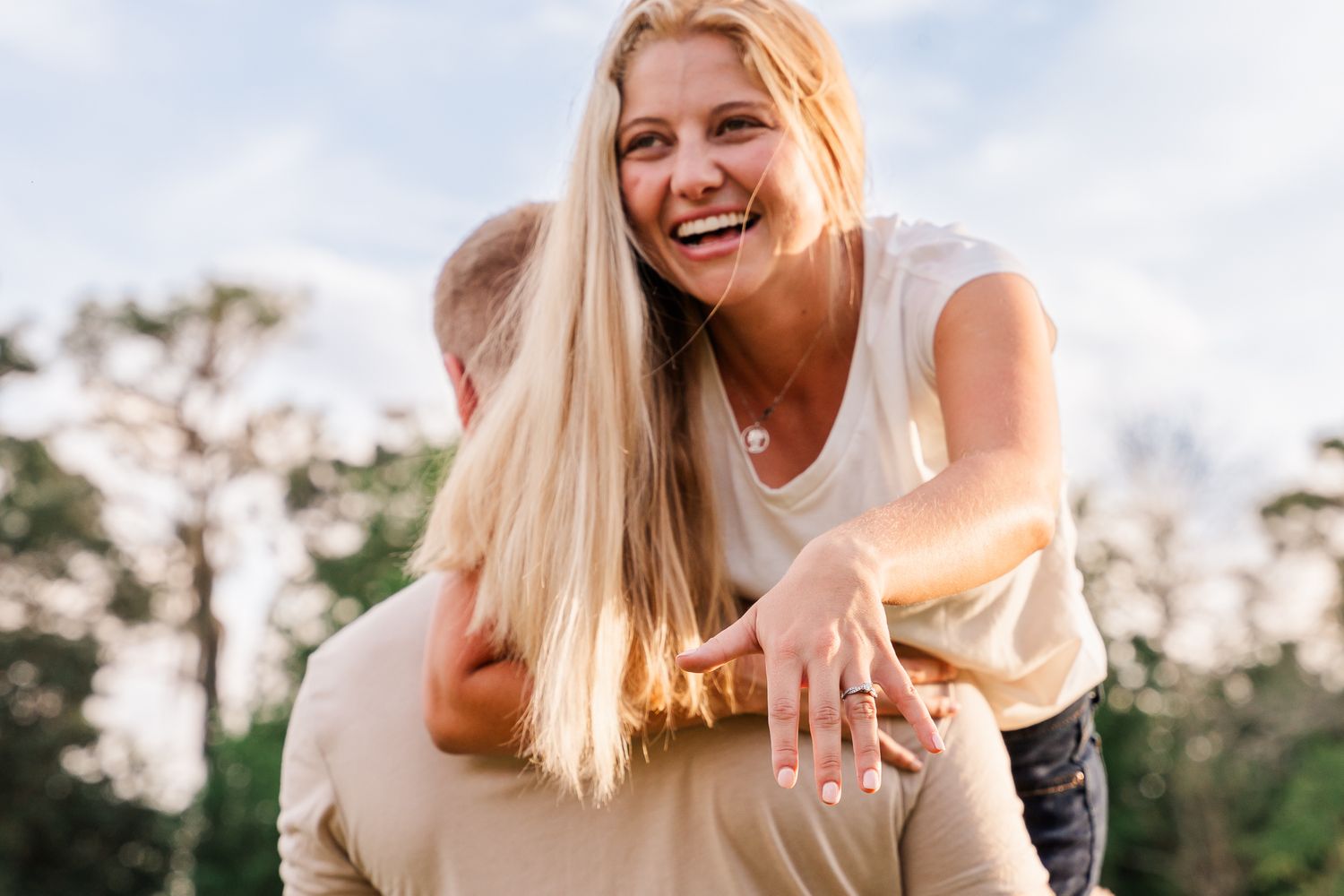 Joyful outdoor portrait showing genuine laughter and happiness at sunset.