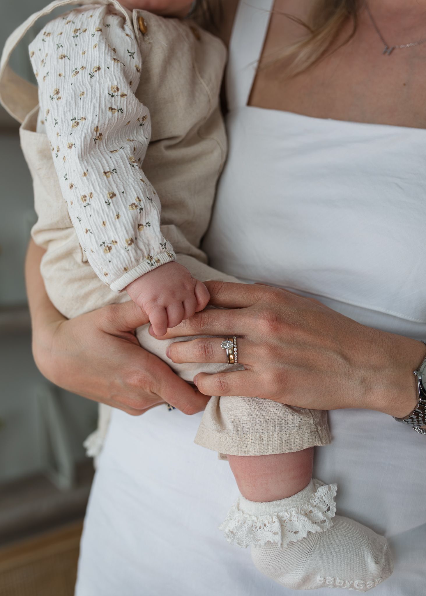 Mother holding her daughter on her hip in-studio