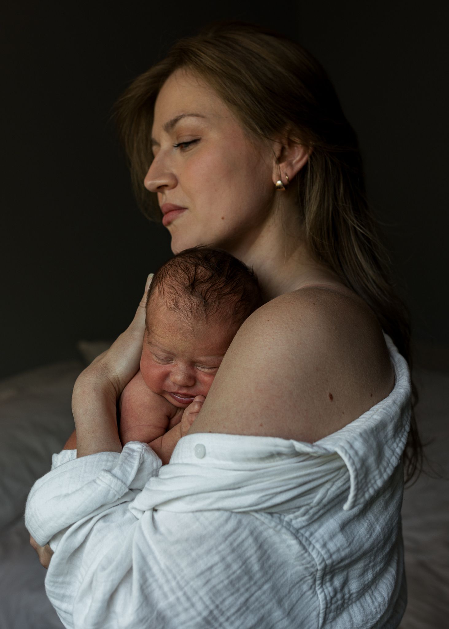 Intimate portrait of a mother holding her newborn