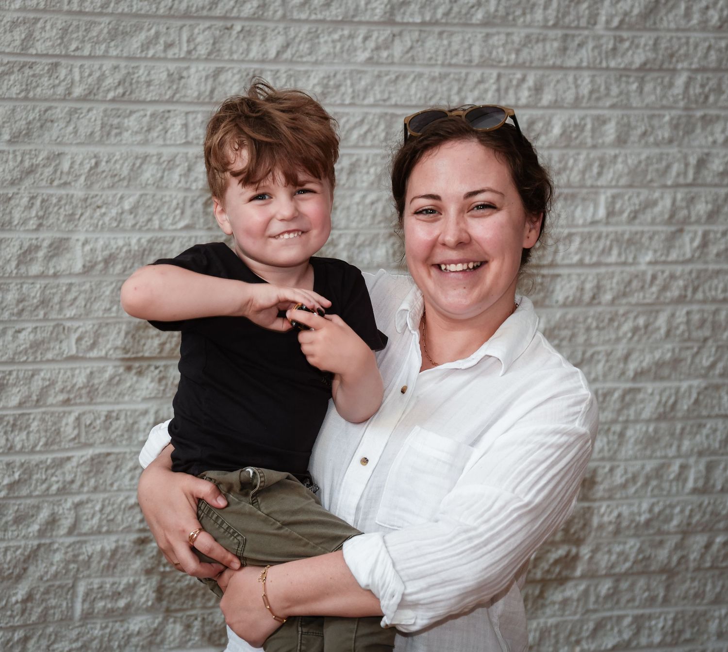 Portrait series against grey brick wall showing candid interactions.