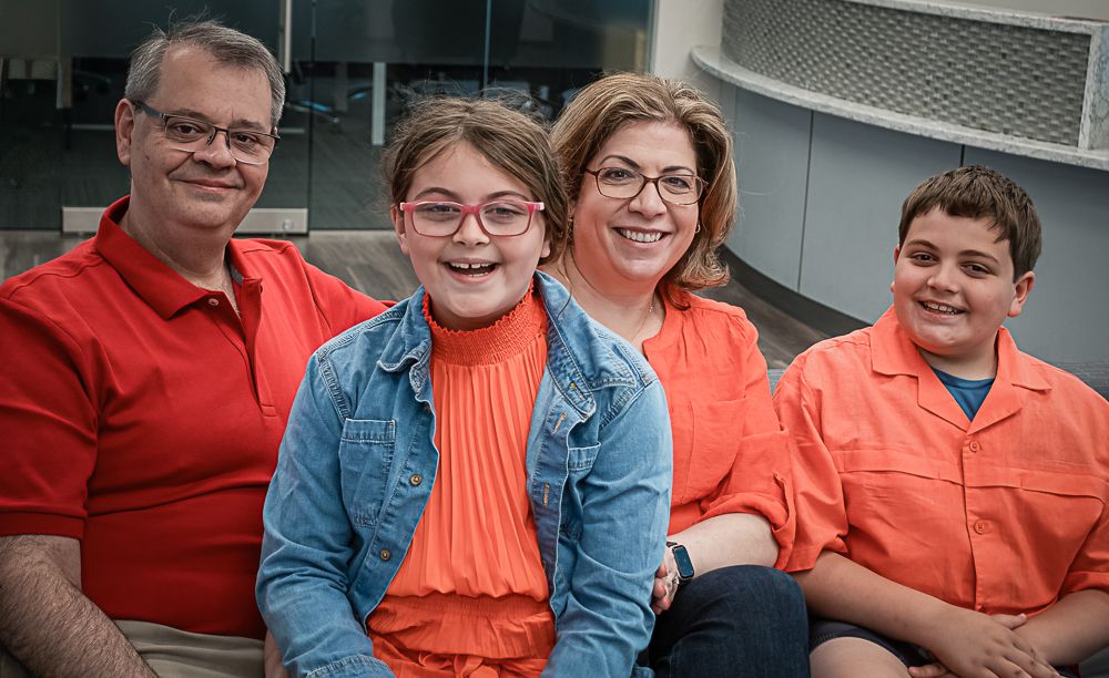 Group photo series featuring coordinated orange and denim outfits.