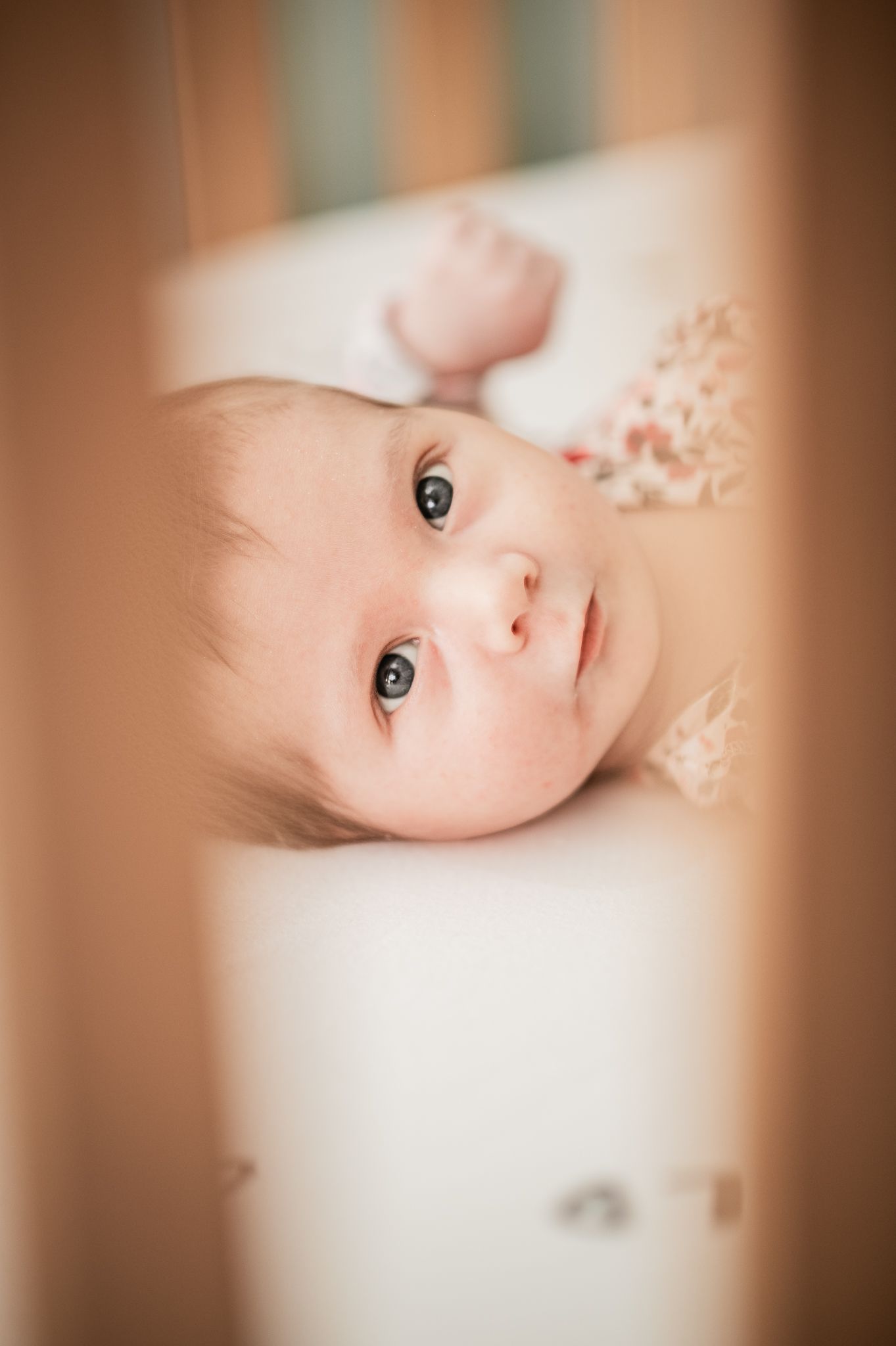 A close-up artistic portrait of a baby with soft focus and warm tones creating a dreamy atmosphere.
