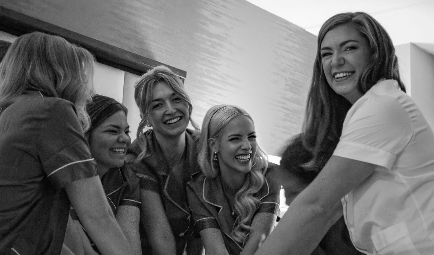 A sequence of candid black and white shots showing joyful laughter and natural reactions.