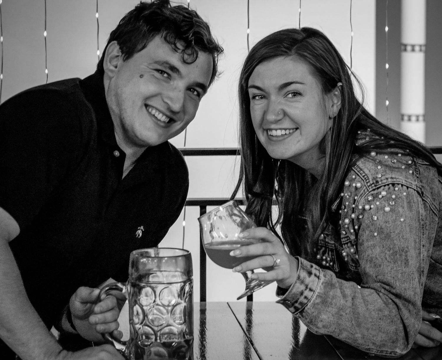 Black and white photo series capturing joyful moments and laughter between people in casual settings.