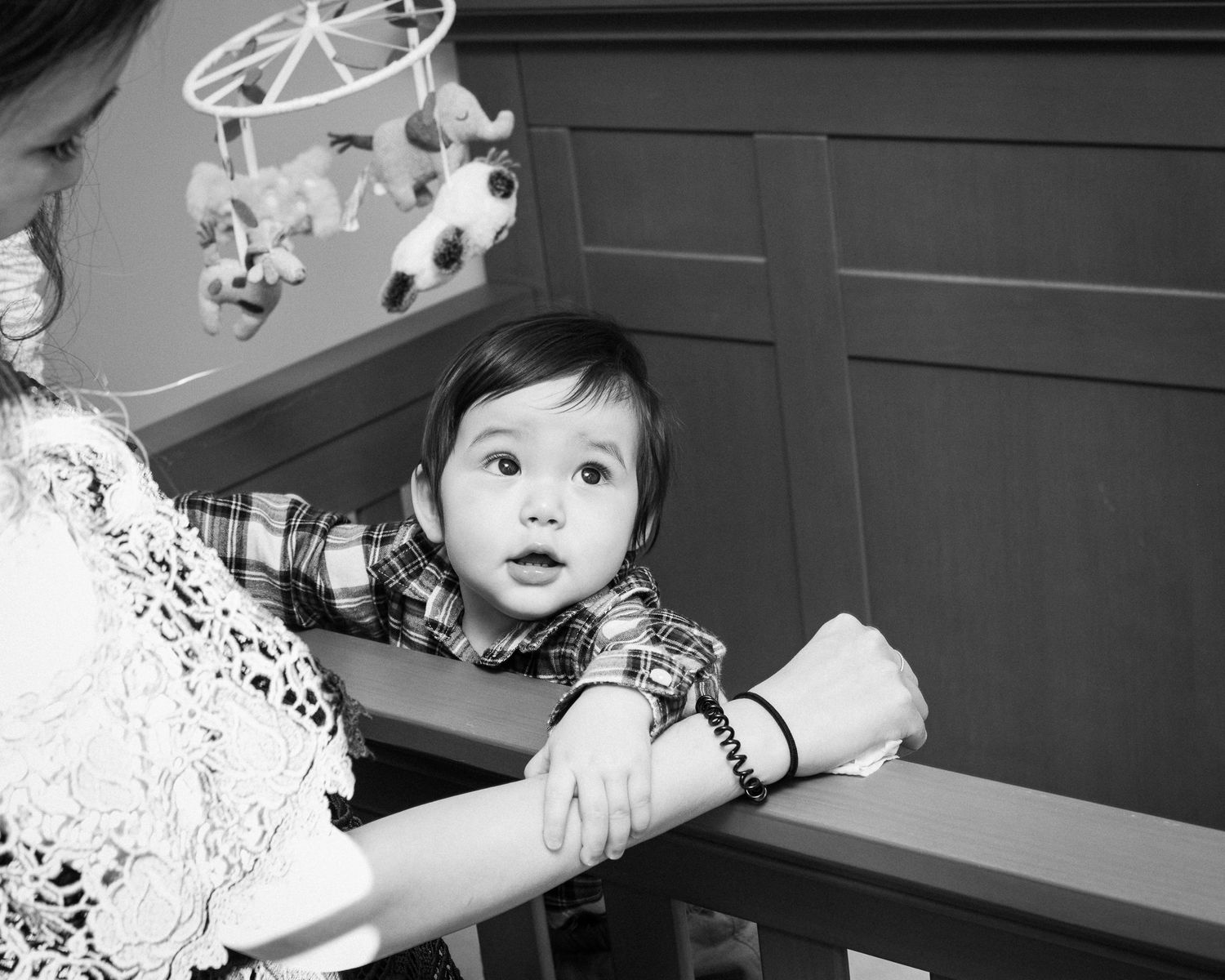 Black and white photo series showing a child playing and exploring in a home setting.