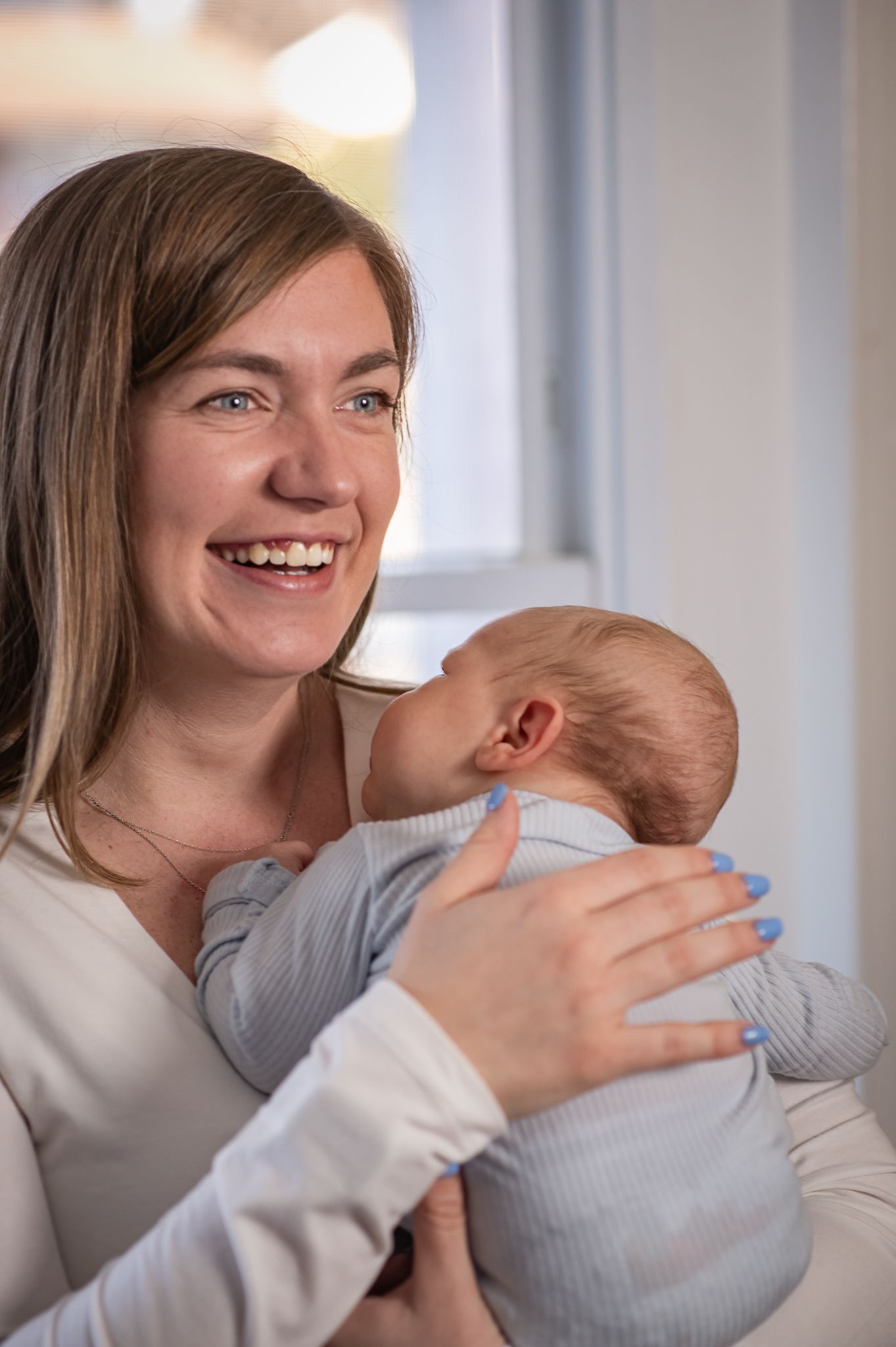 A series of four connected photos showing tender moments between a parent and baby in soft natural lighting.