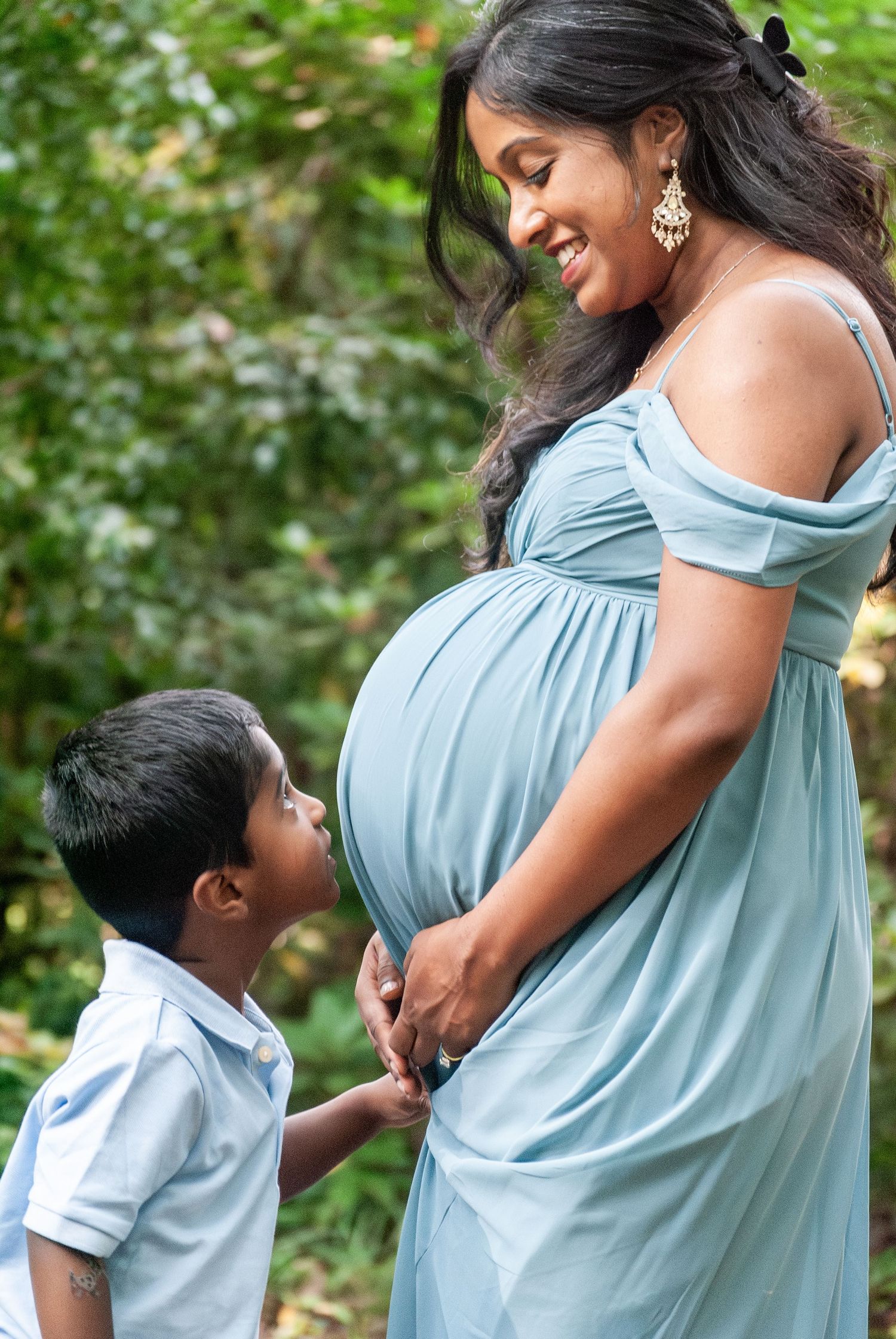 A touching maternity photoshoot sequence showing tender moments between parent and child in an outdoor garden.