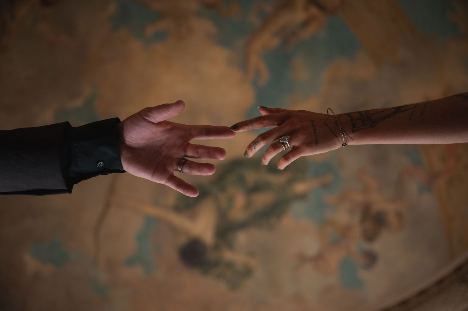 Two hands reaching toward each other against a vintage map background, symbolizing connection and togetherness.