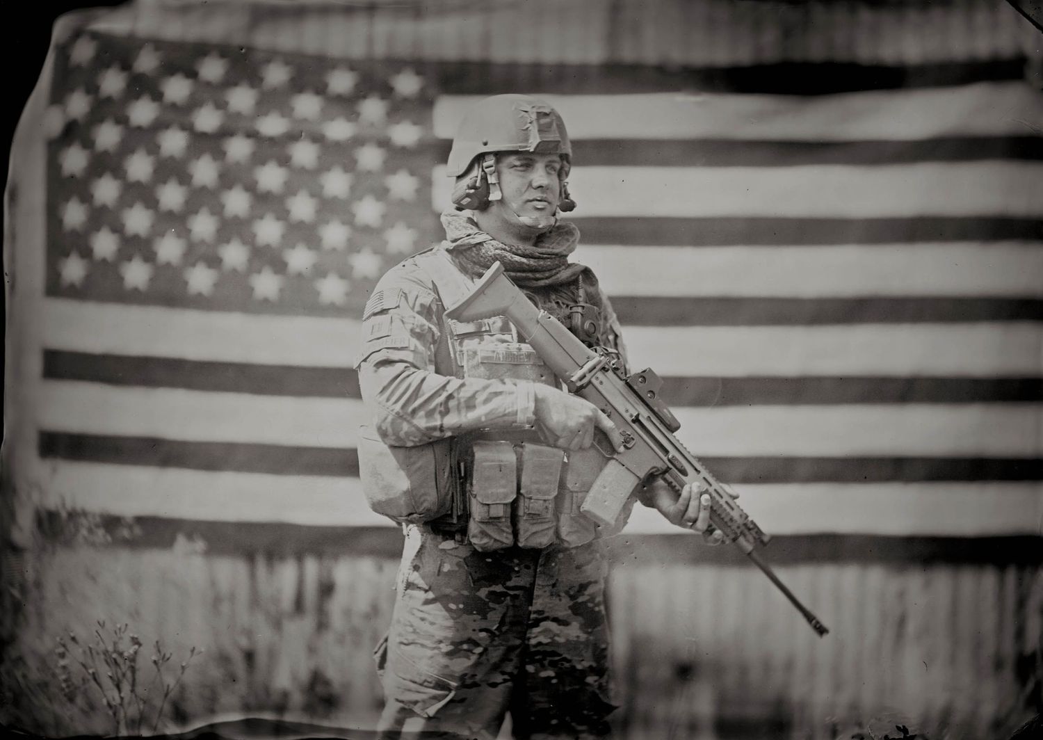 tintype of soldier in front of large American flag