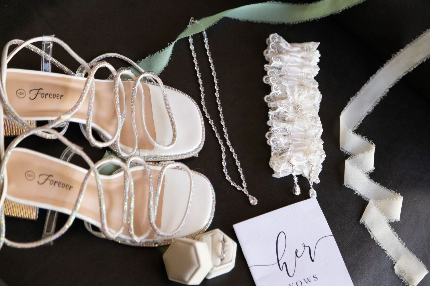 Delicate white silk wedding hangers decorated with lace and ribbons for displaying bridal dresses.