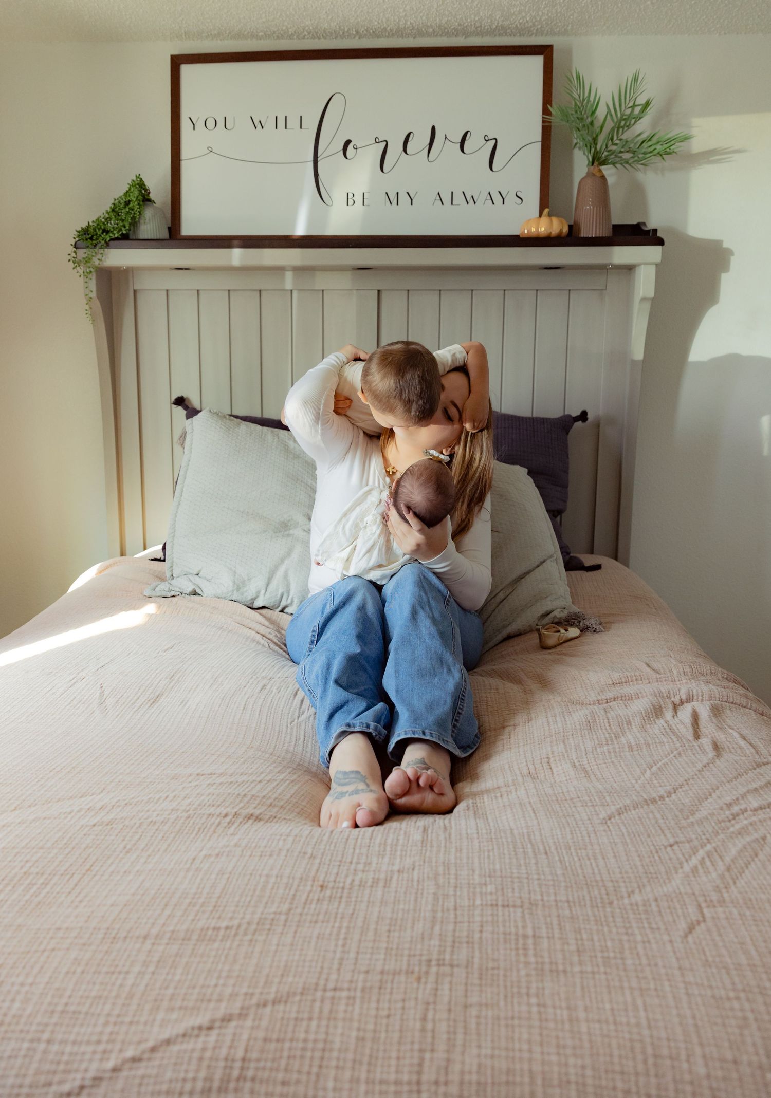 Bedroom scene with white farmhouse headboard and 'Forever be my always' sign above bed.