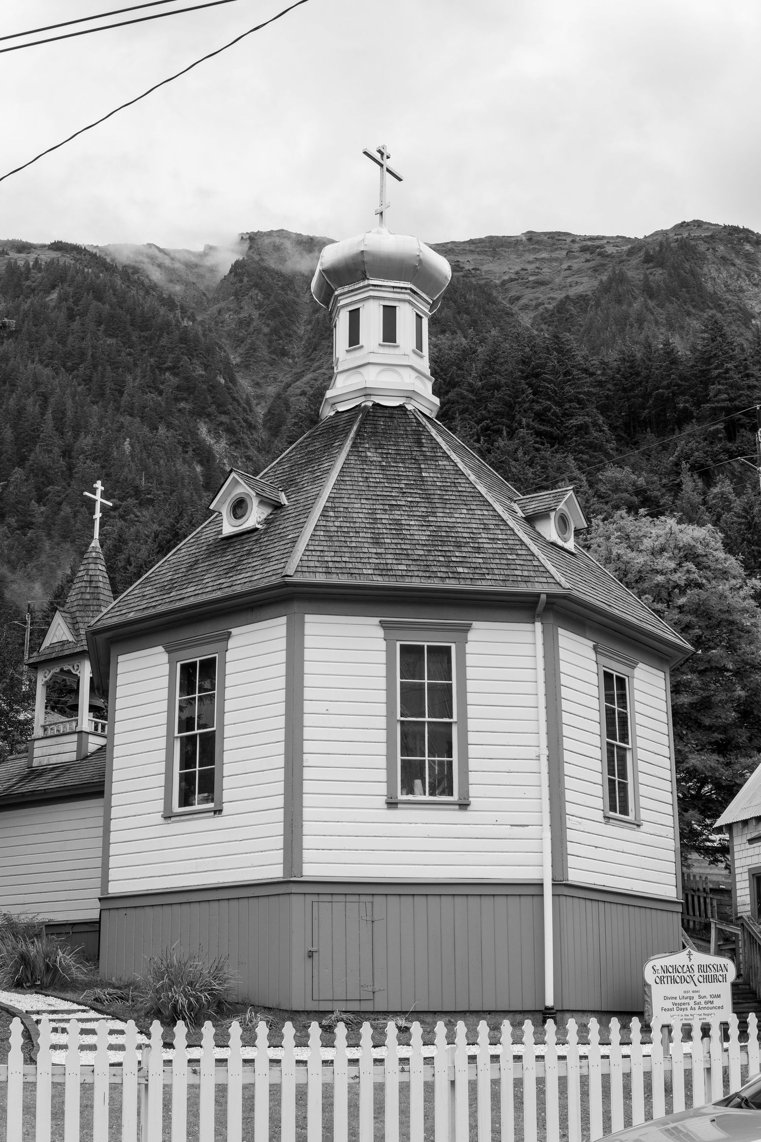 Historic Russian Orthodox church with white walls and onion dome in Juneau.
