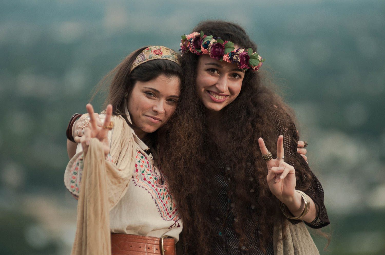 Portrait of two hippie girls outside