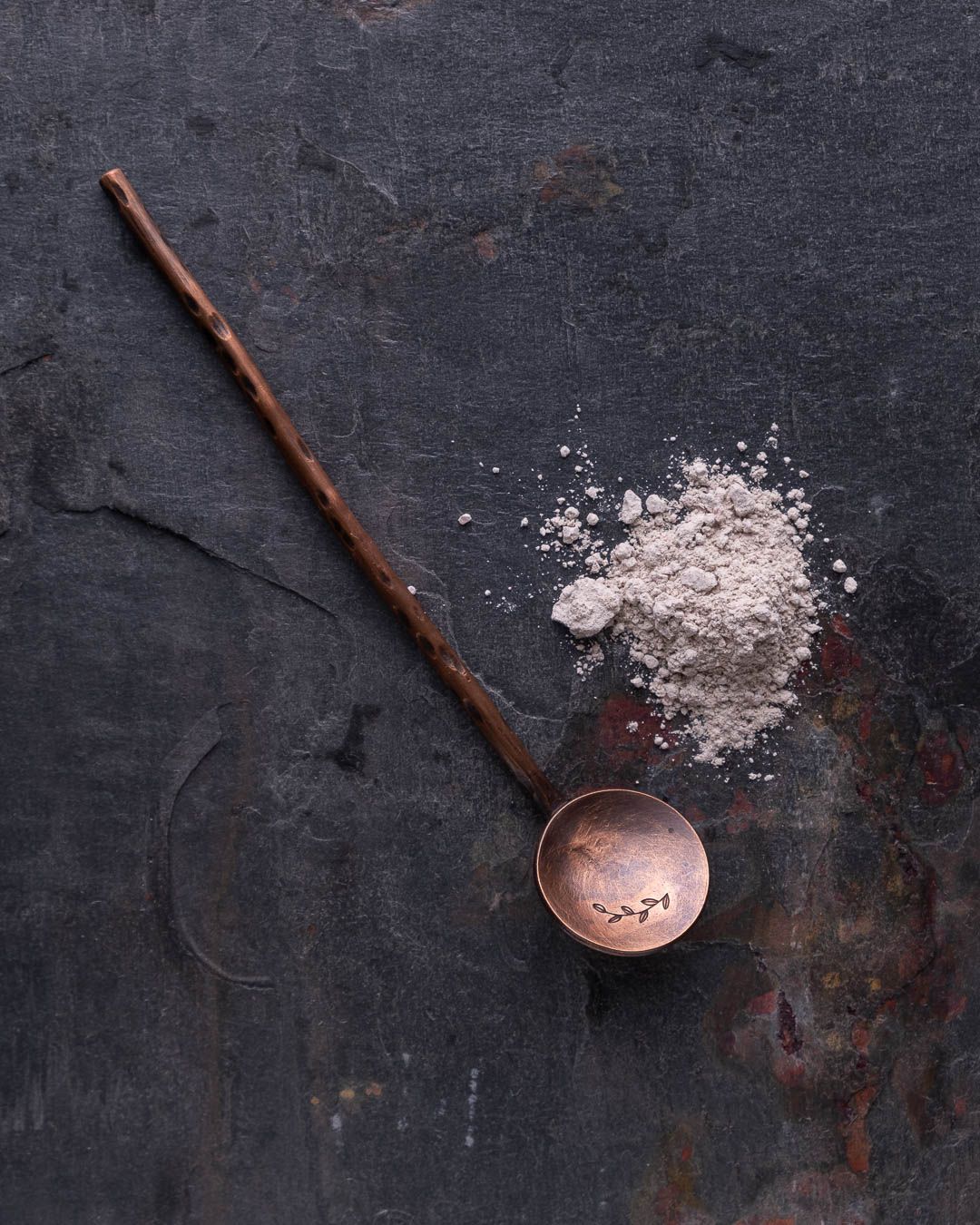 Branding photo of a spoon and spice powder