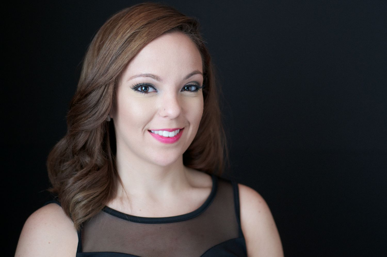 Stylized headshot of young woman with brown hair in studio