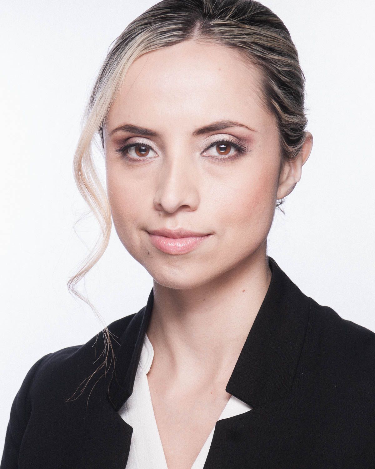 Stylized headshot of young woman with light hair in studio