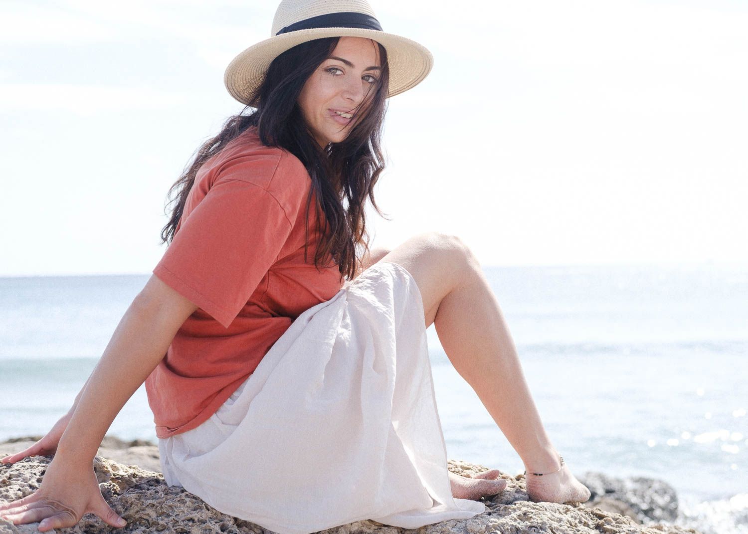 Lifestyle photo of a young woman at the beach.
