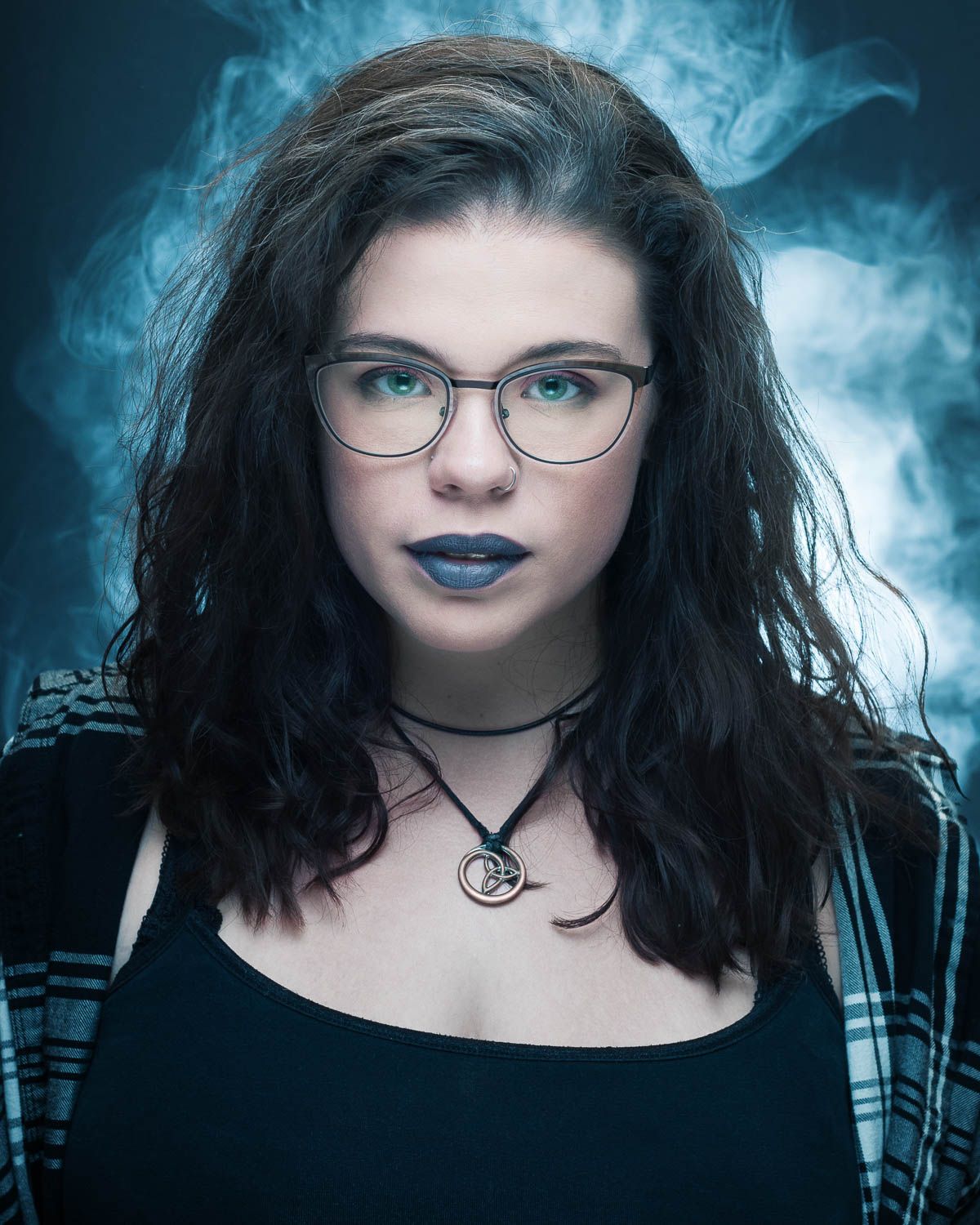 Stylized portrait of young woman with dark hair in studio