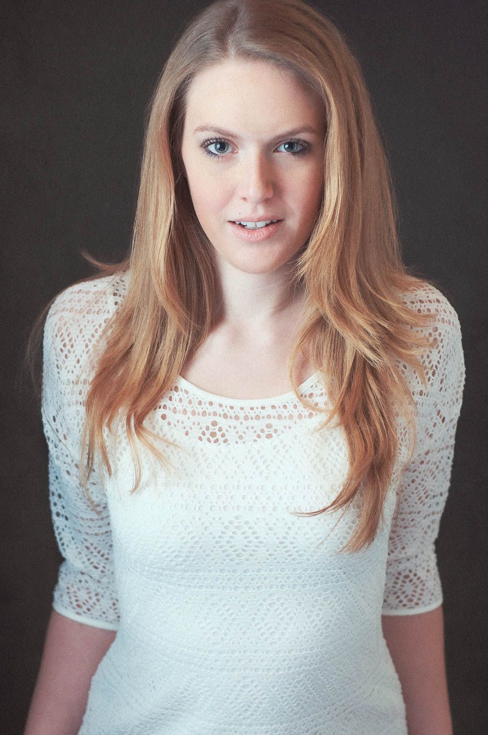 Creative portrait of young woman with light hair in studio