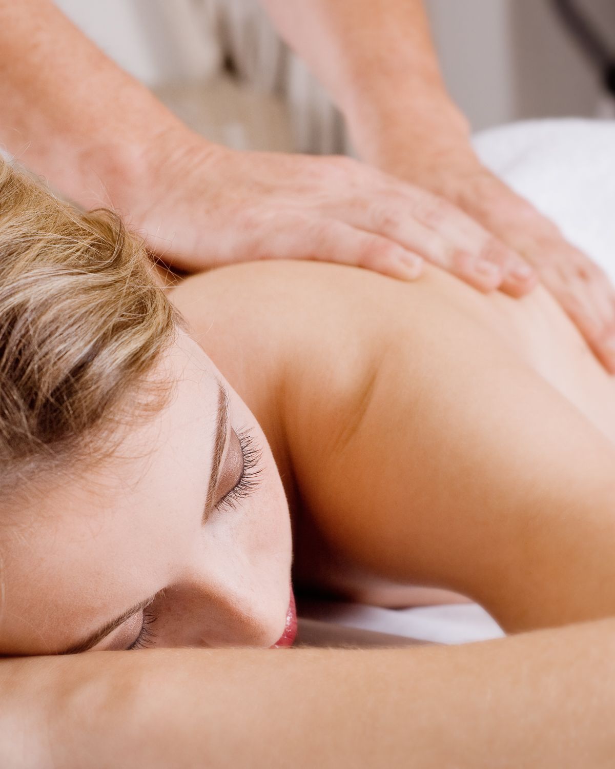 Branding photo of young woman getting a professional massage.