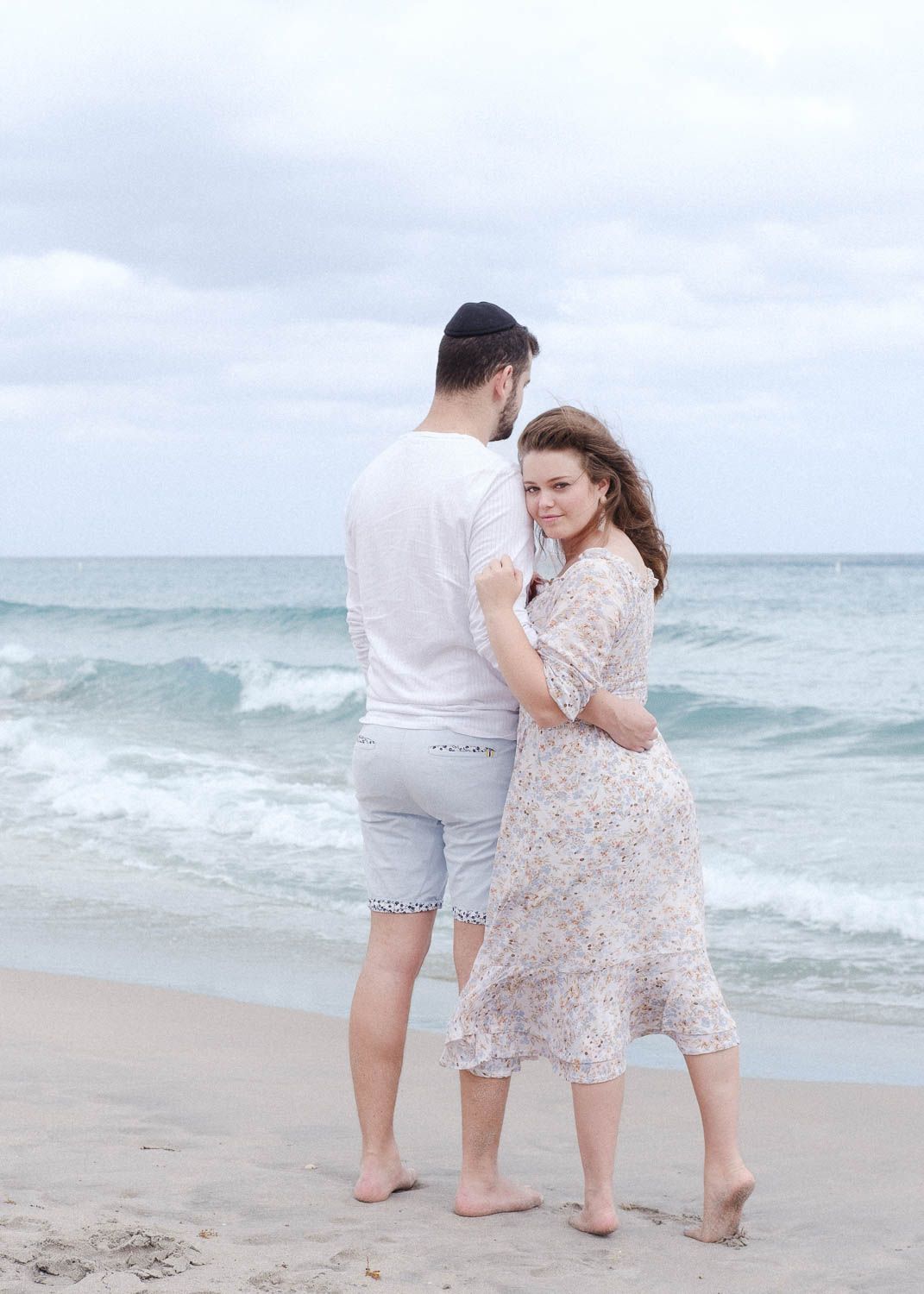 Lifestyle photo of a young woman and man at the beach