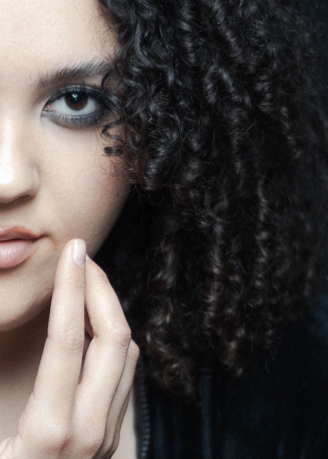 Portrait of young woman with dark hair in studio