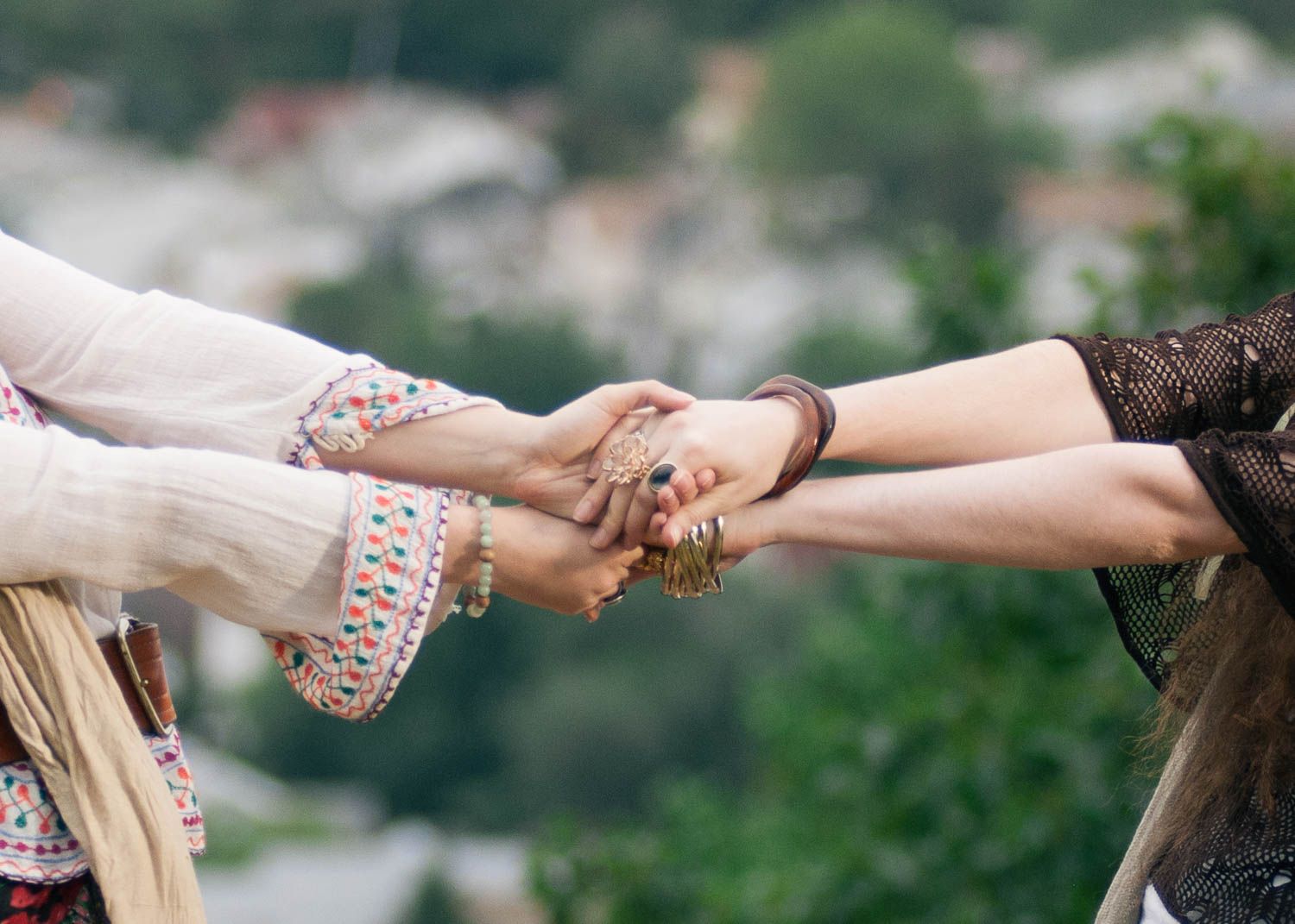Portrait picture of two women outside grabbing hands