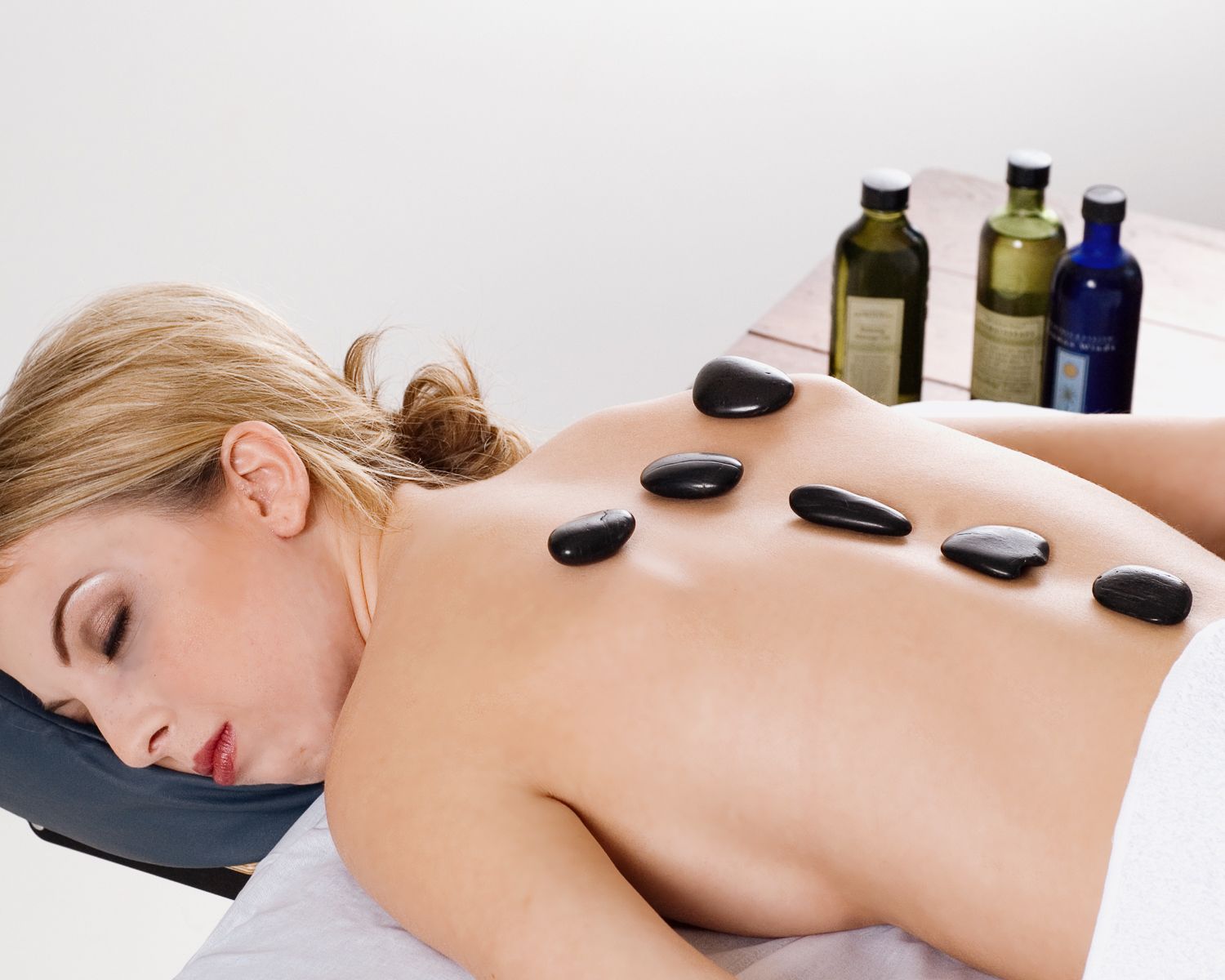 Branding photo of young woman getting a professional massage.