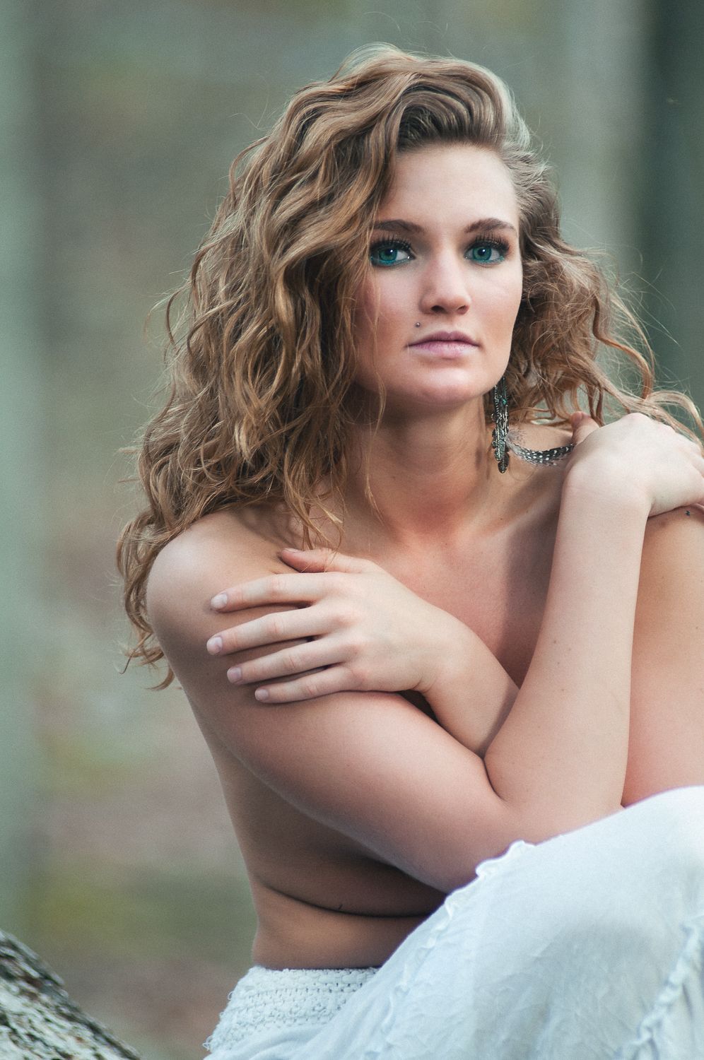 Portrait of a woman with light hair out in the woods