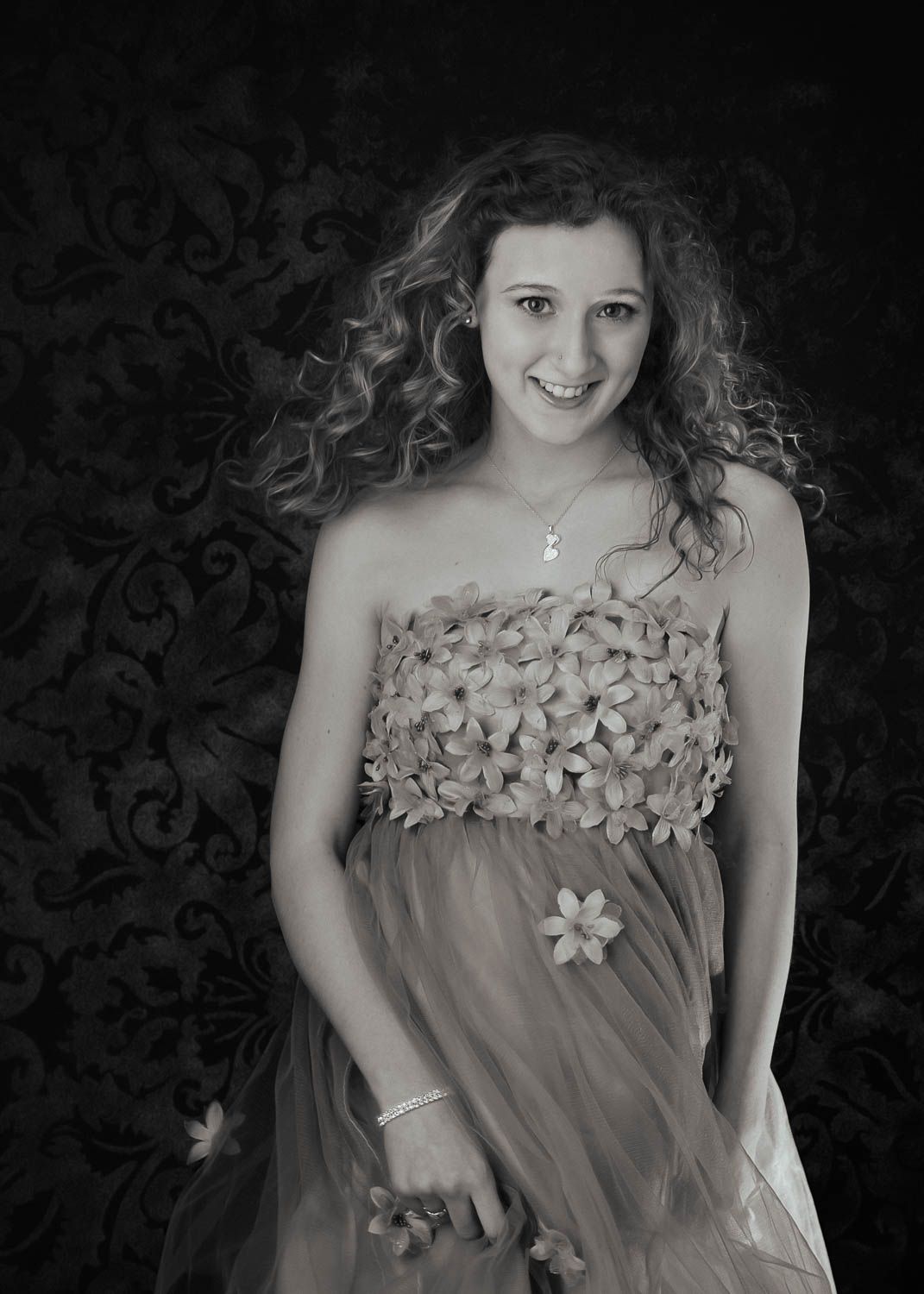 Creative black and white portrait of young woman in a dress in studio