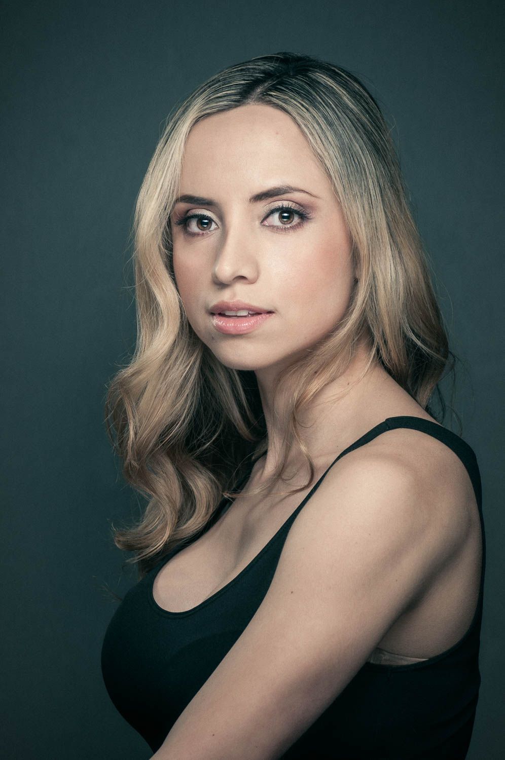 Creative portrait of young woman with light hair in studio
