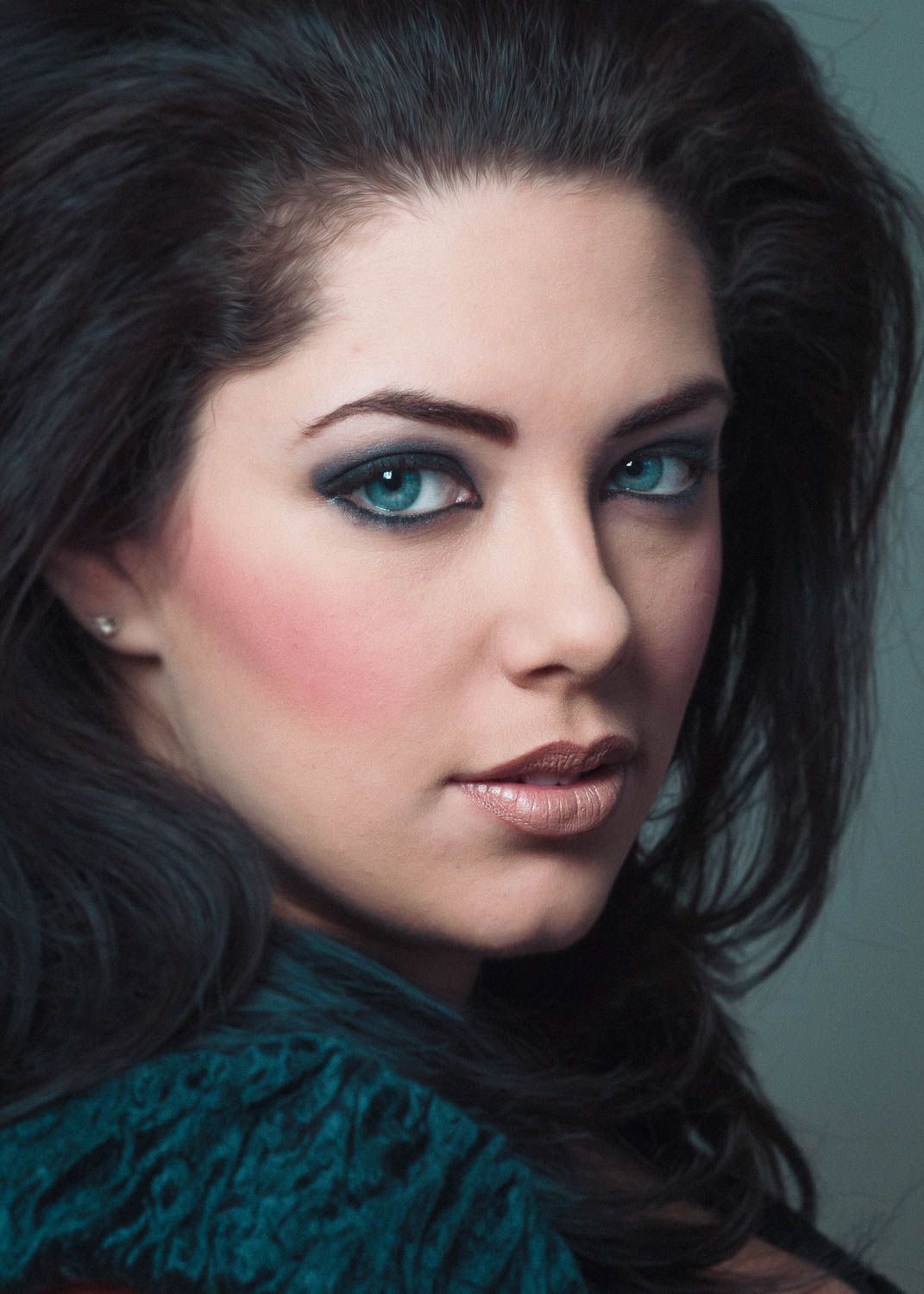 Portrait of young woman with dark hair in studio