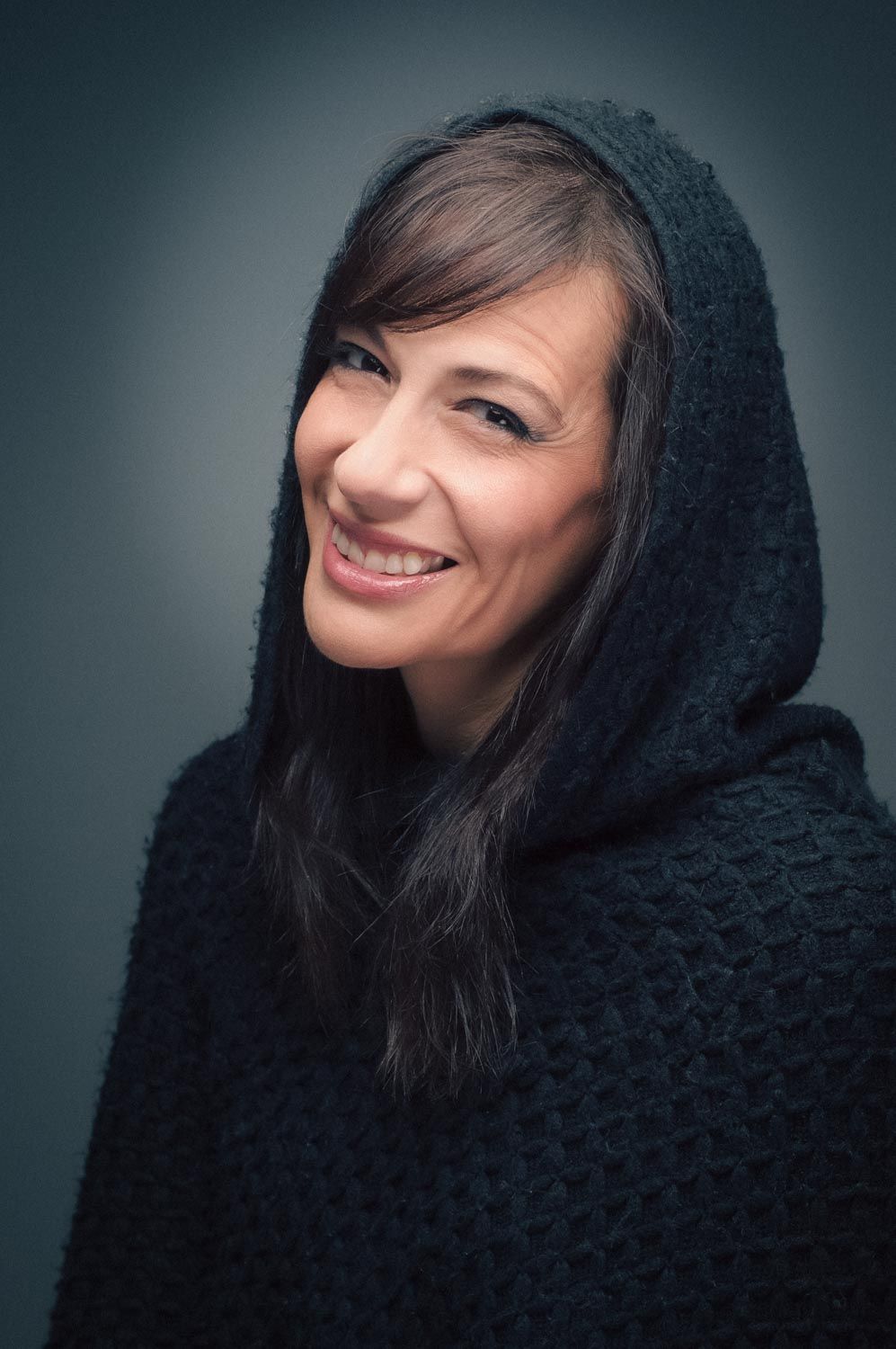 Portrait of young woman with dark hair in studio