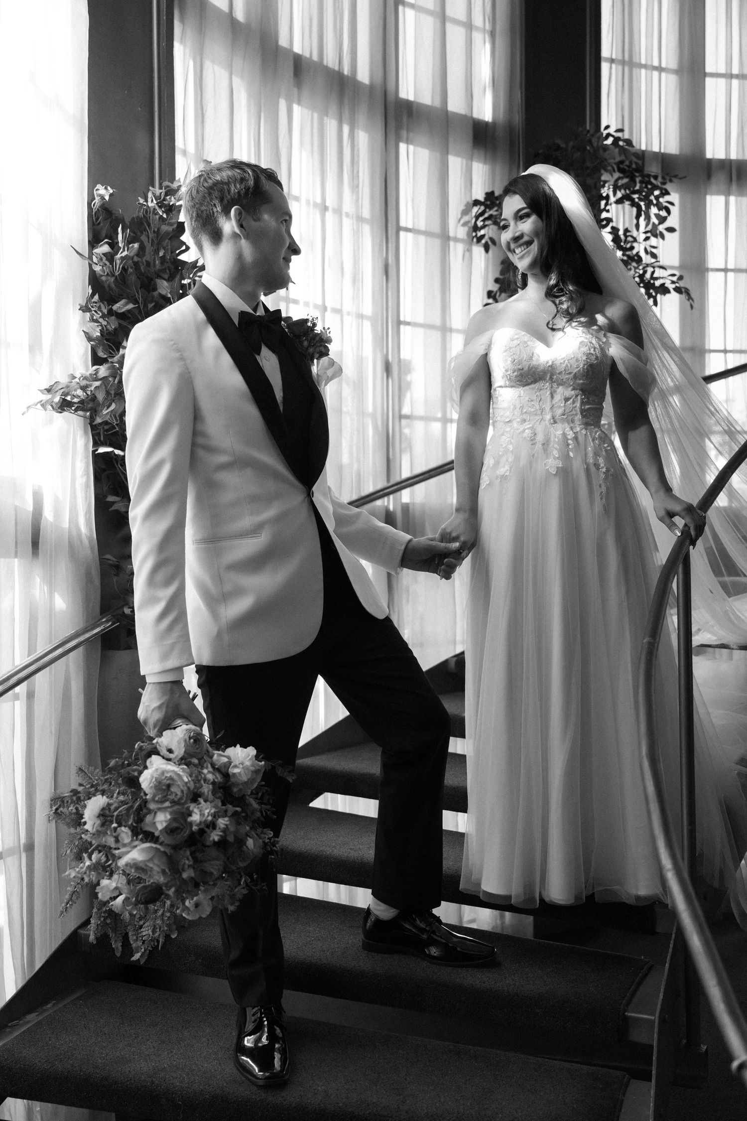Black and white artistic sequence of figures dancing by windows with flowing curtains and floral arrangements.