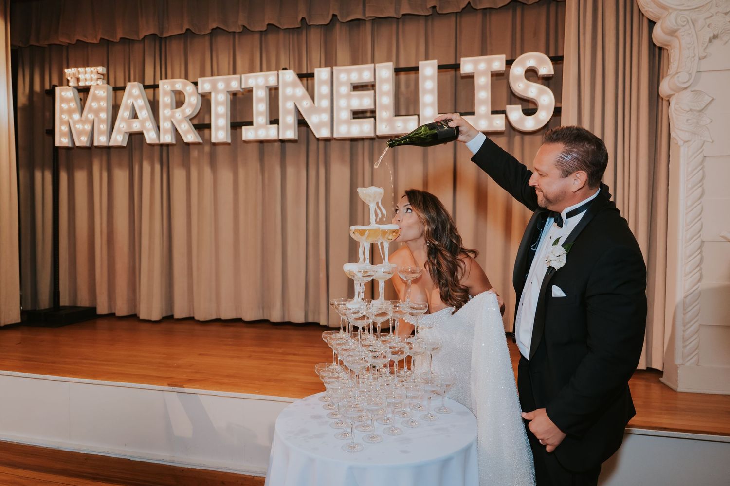 Wedding reception venue interior with Martinelli's branding and elegant lighting.